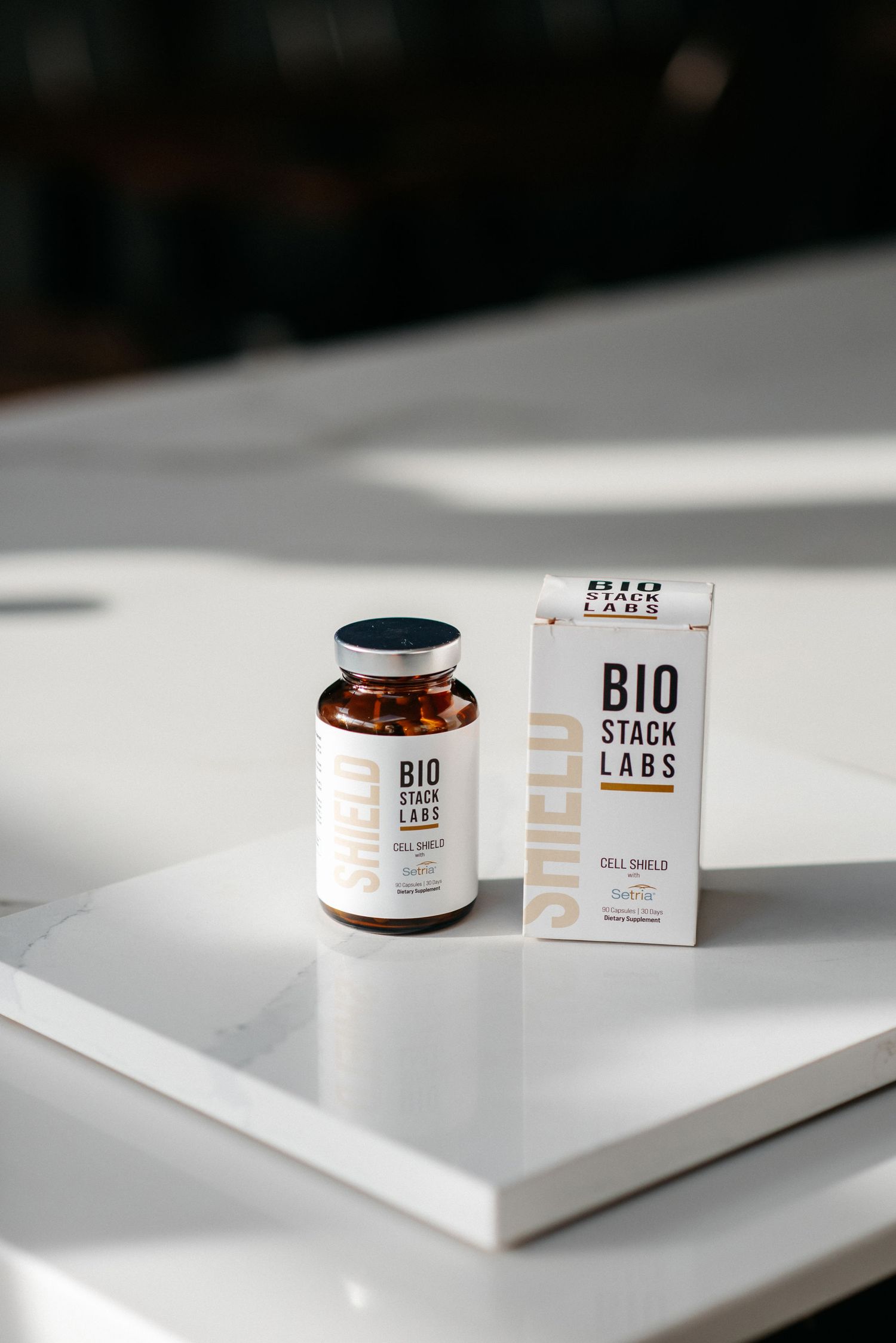 A series of minimalist product shots showing skincare jars and packaging on white surfaces in clean, modern lighting.
