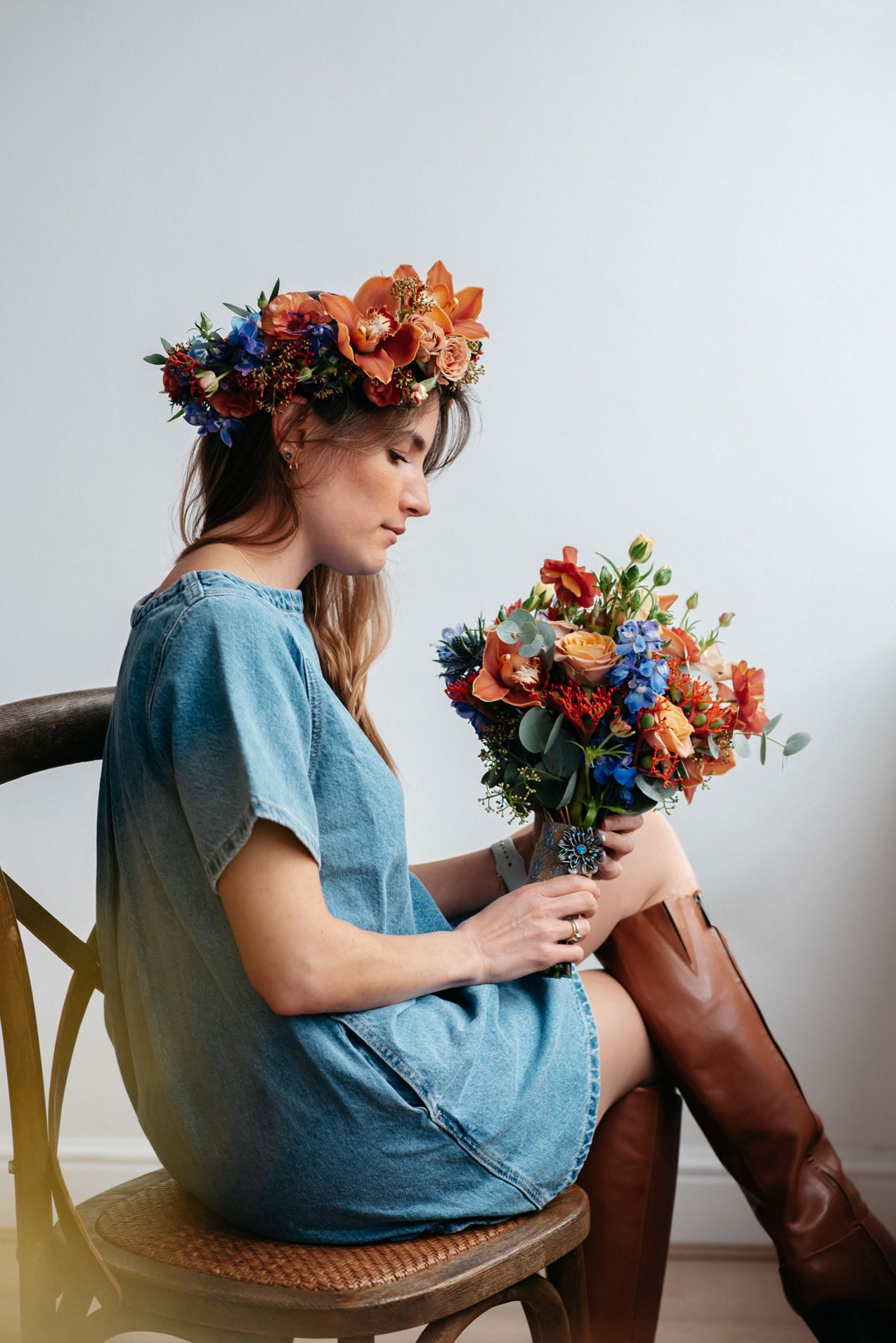 lifestyle photograph of a woman holding a bouquet of beautiful flowers at a floral workshop