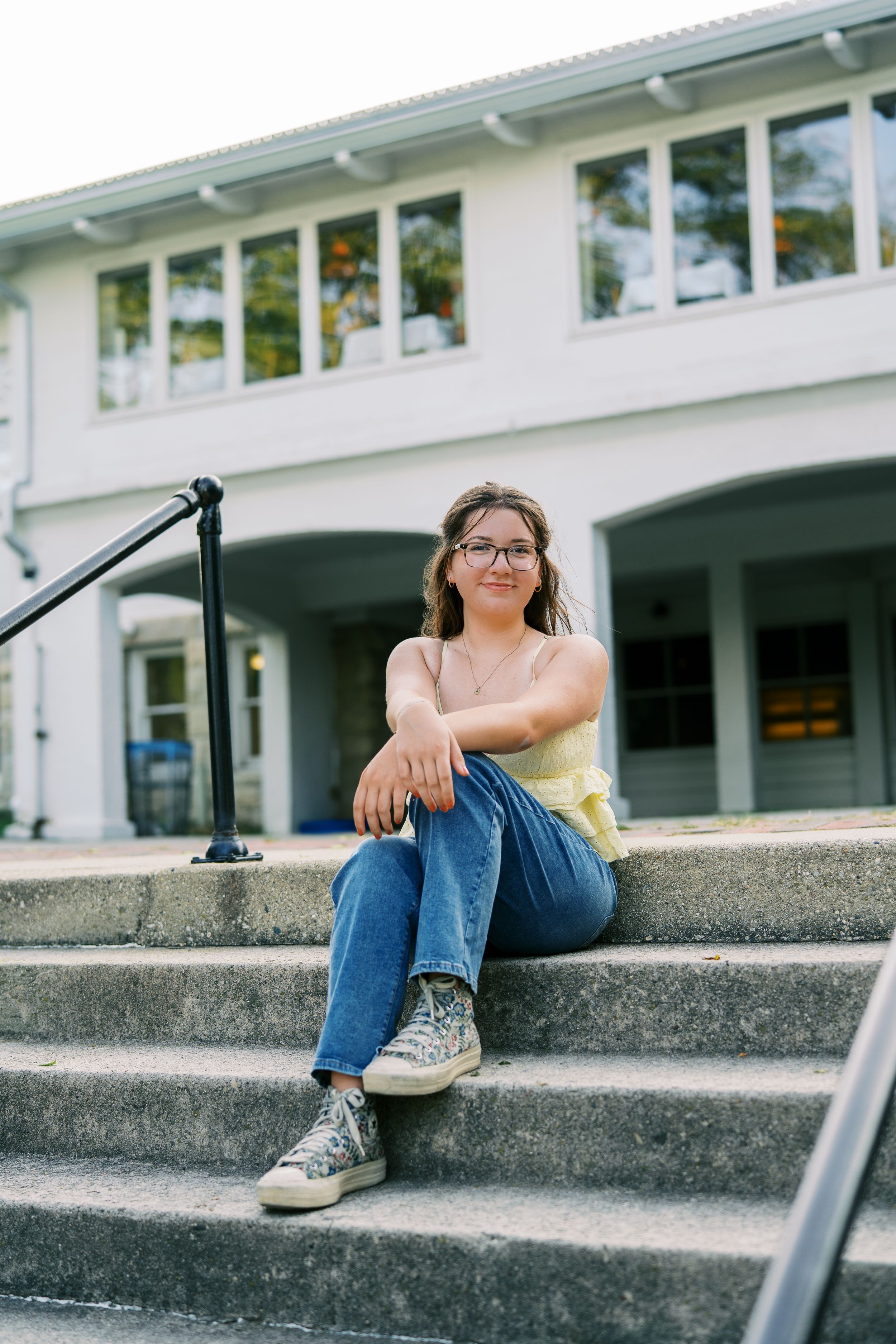Artistic series of someone relaxing on concrete steps with sneakers and jeans.
