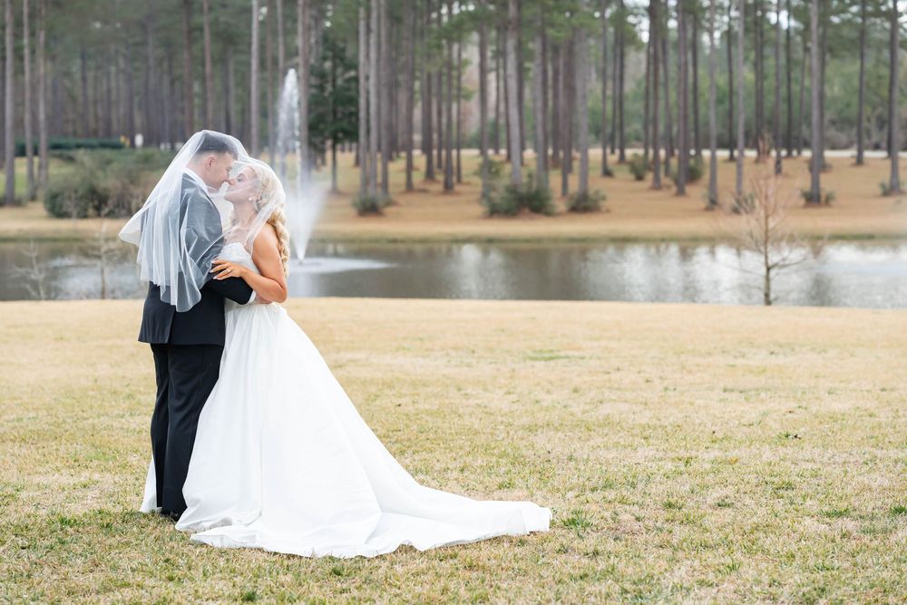 bride and groom under veil