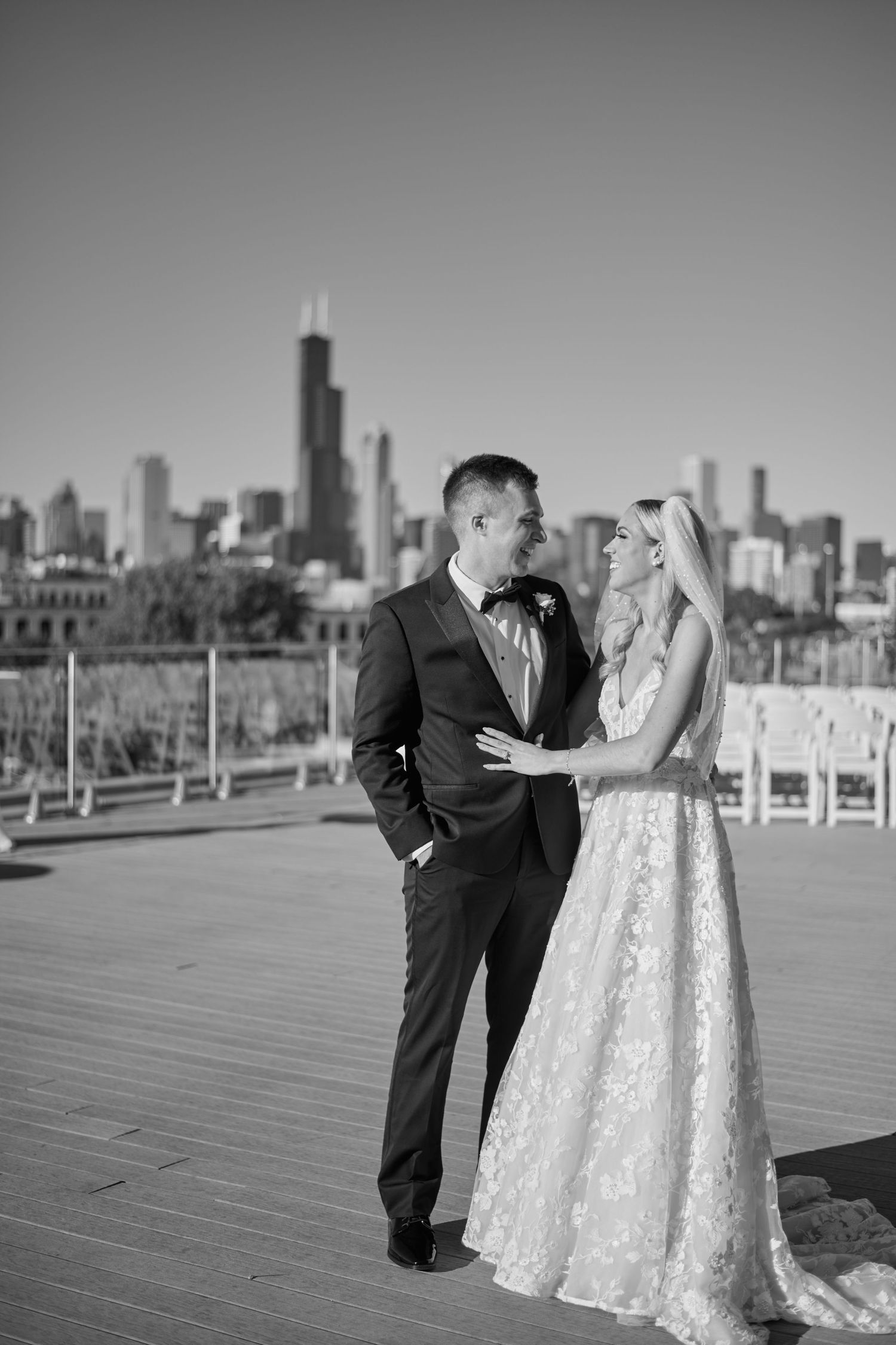 A romantic black and white wedding photoshoot sequence on a boardwalk with the Chicago skyline in the background.