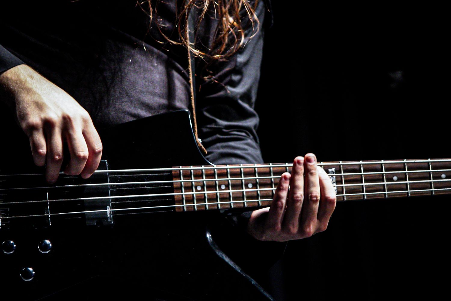 Musicien jouant de la guitare en concert, lumière et ambiance, photographie artistique