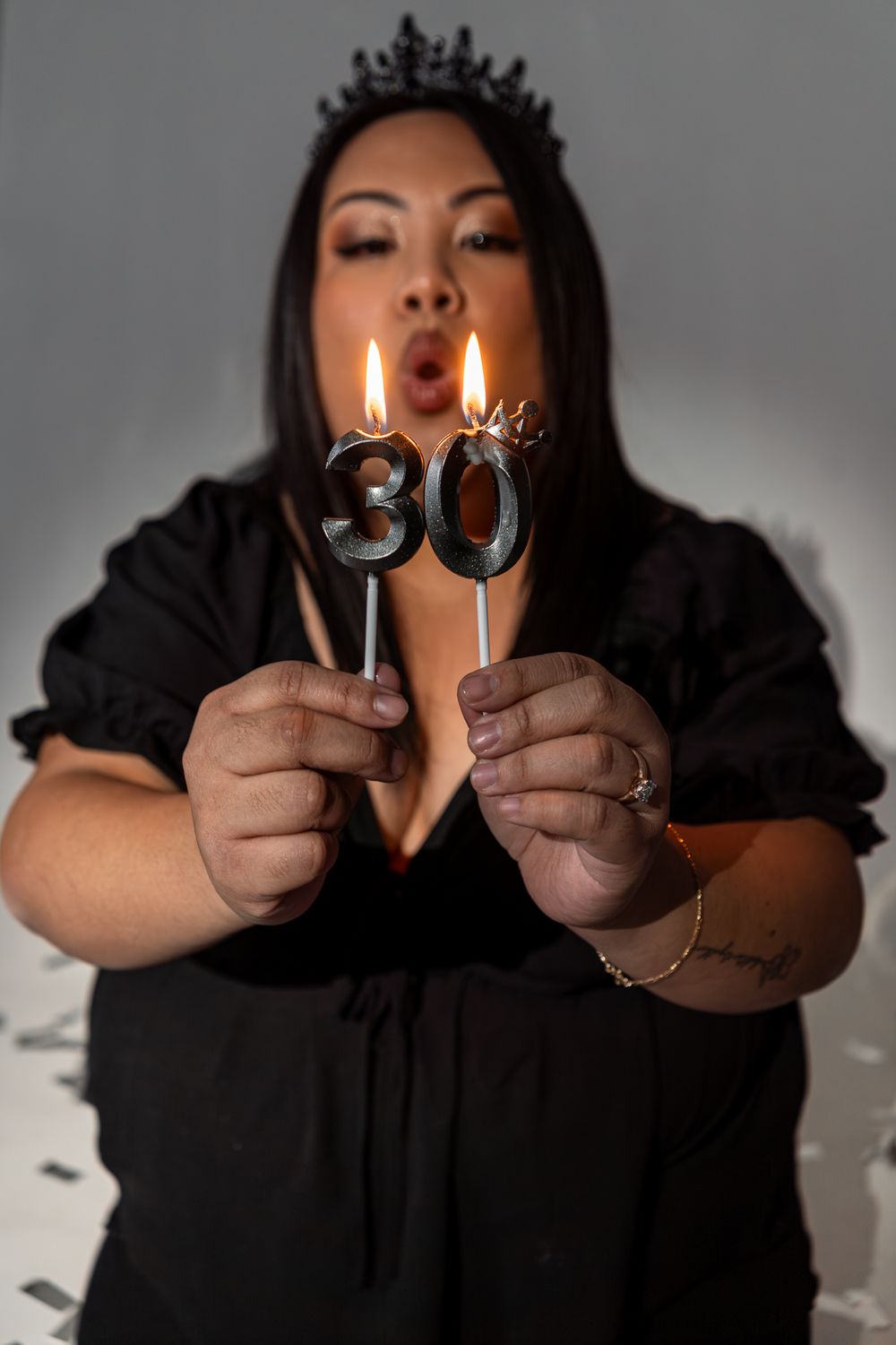 A sequence of photos showing hands holding number candles that spell out '30' with lit flames against a dark background.