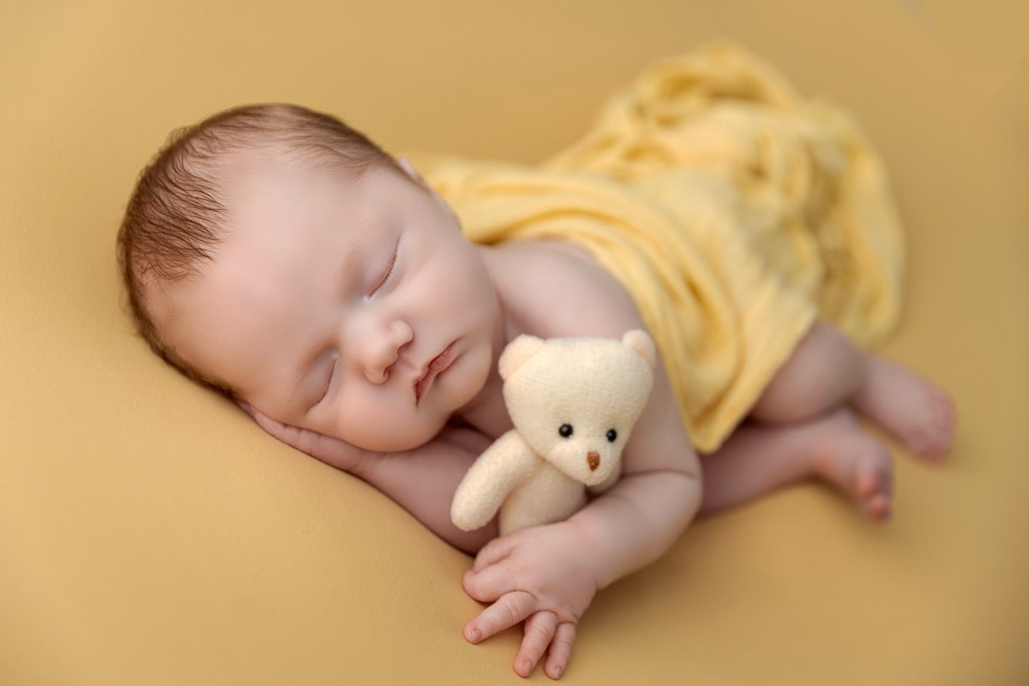 A tender series of intimate black and white photos showing nurturing moments between parent and newborn.