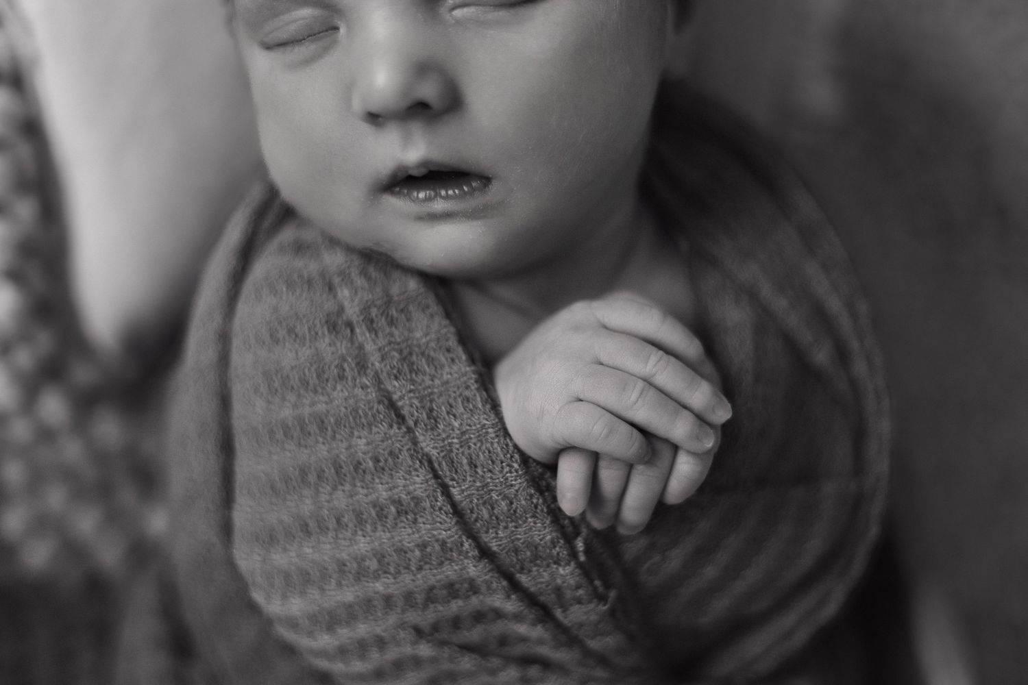 A black and white photo series shows a baby's expressions changing from serious to smiling in six sequential frames.