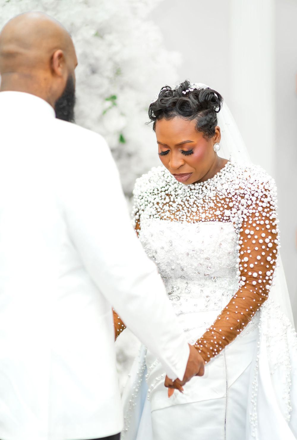 Elegant bridal gown with sheer dotted sleeves and high neckline details shown from multiple angles.
