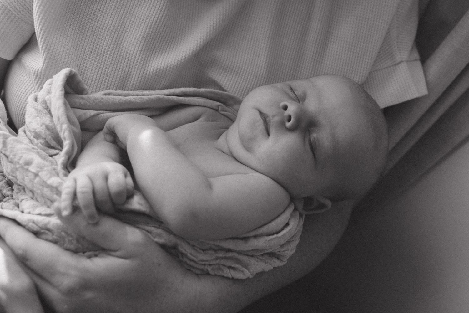 A series of black and white photographs showing a baby's face in various expressions and angles.