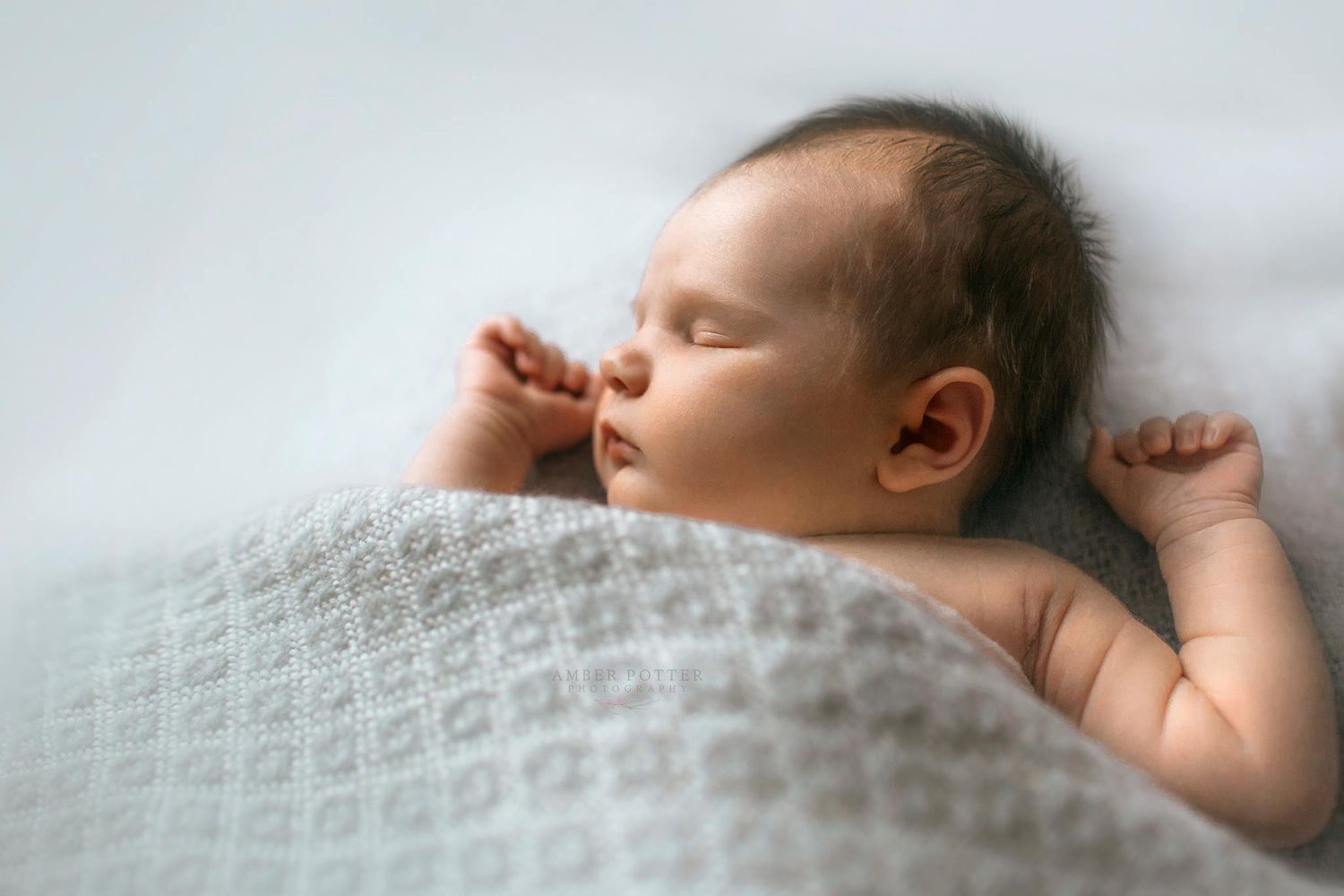 Close-up of newborn wrapped in neutral blanket – Amber Potter Photography Springfield Missouri.