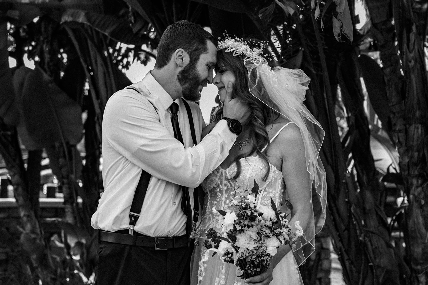 Couple looking into each other's eyes while the male is cradling the females face with his hands.