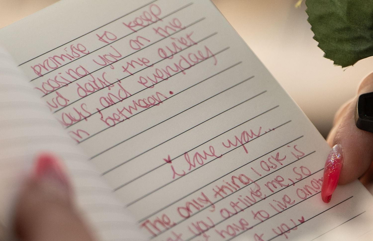 Handwritten love letter in red ink on white paper with heartfelt message and cursive writing.
