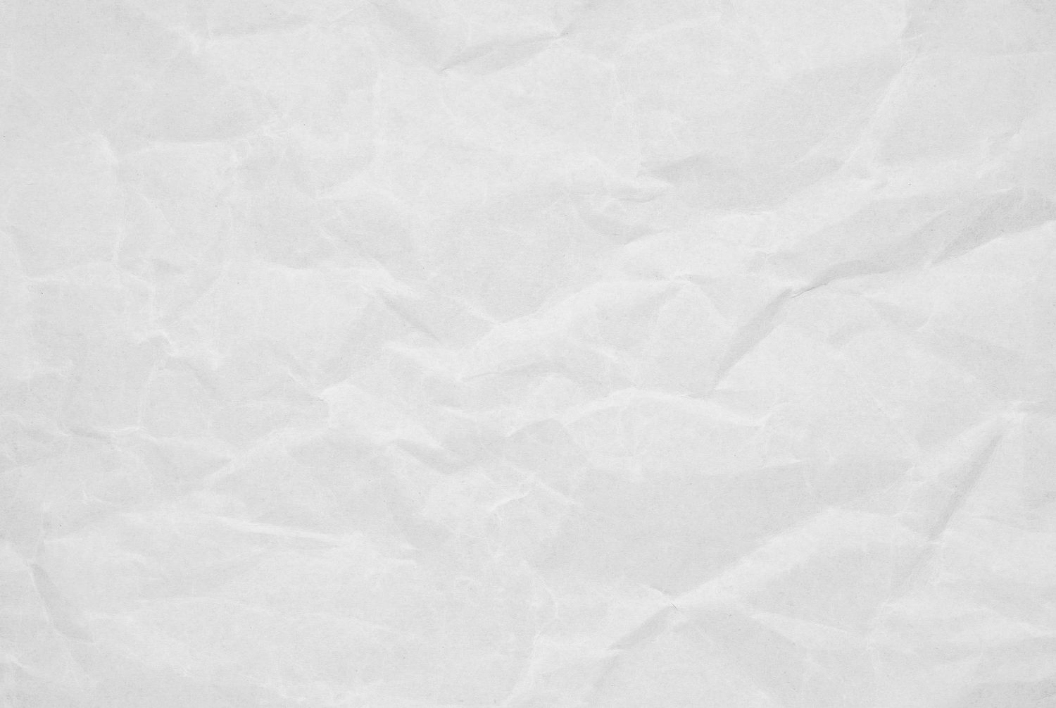 White crumpled paper texture with soft creases and folds creating a subtle pattern.