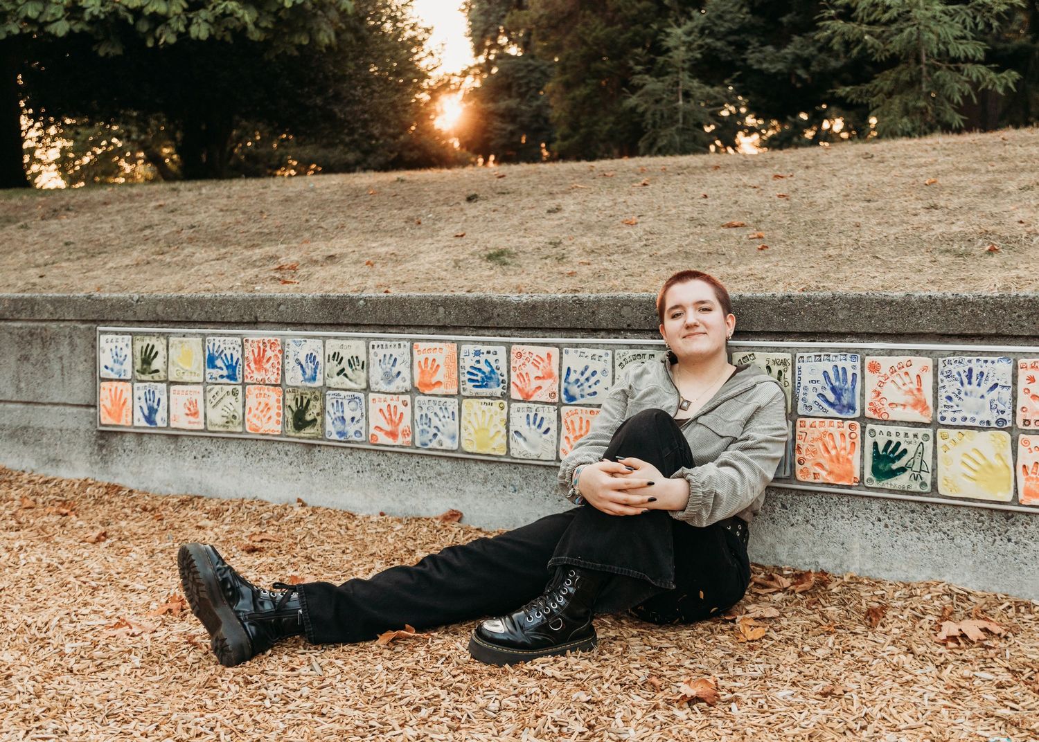 A sequence of images showing someone lying down in different positions next to a colorful tiled wall outdoors.
