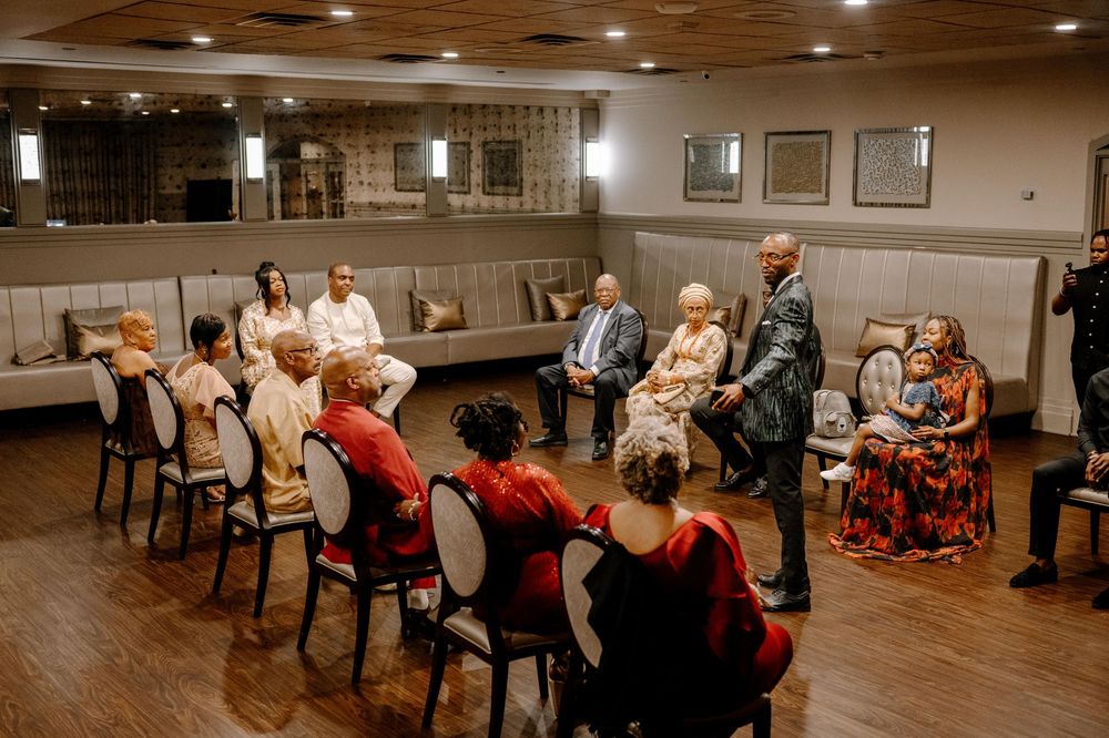 People gathered in a community room with chairs arranged in rows for an event.