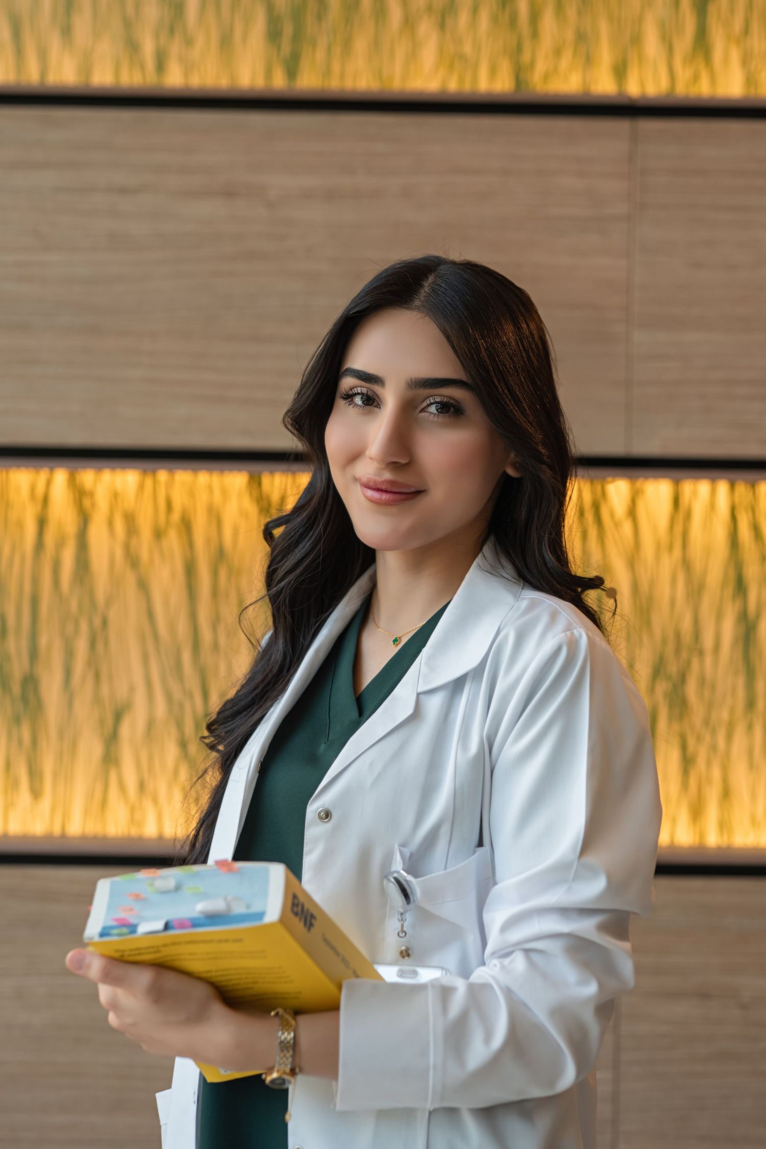 Healthcare professional in white coat reading medical documents in modern office with warm lighting.