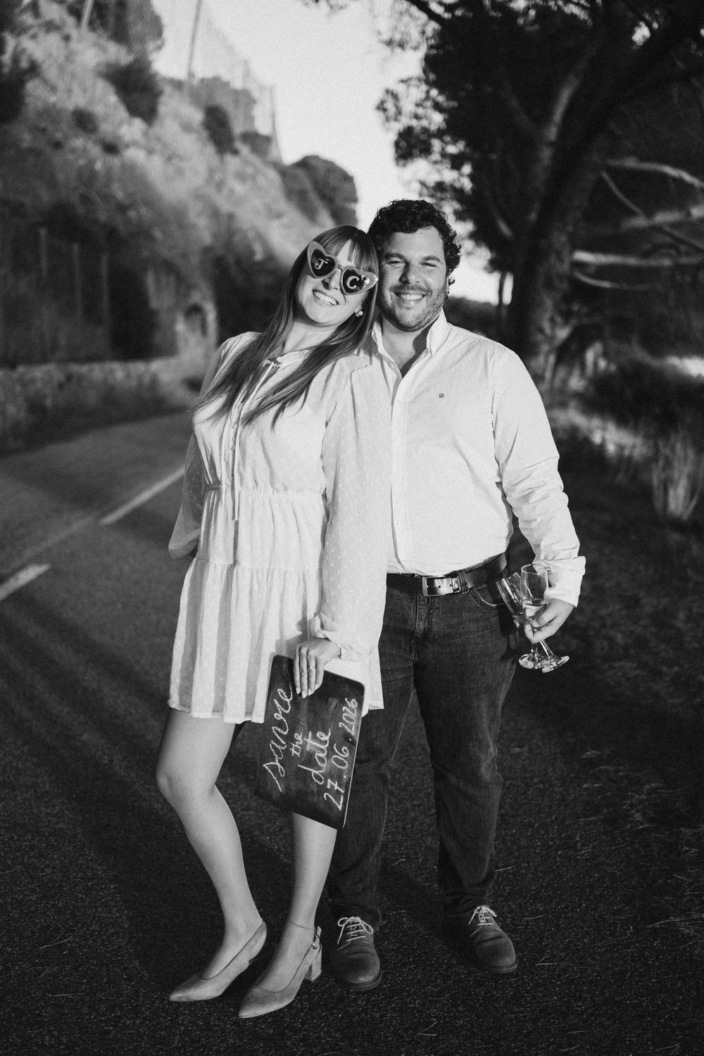 A black and white photo sequence showing a couple walking together on a country road.