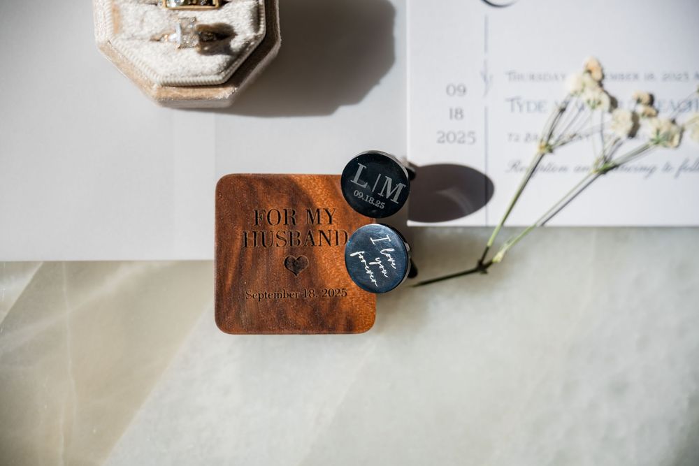 Wedding day details including rings, stationery and delicate floral elements on light background.