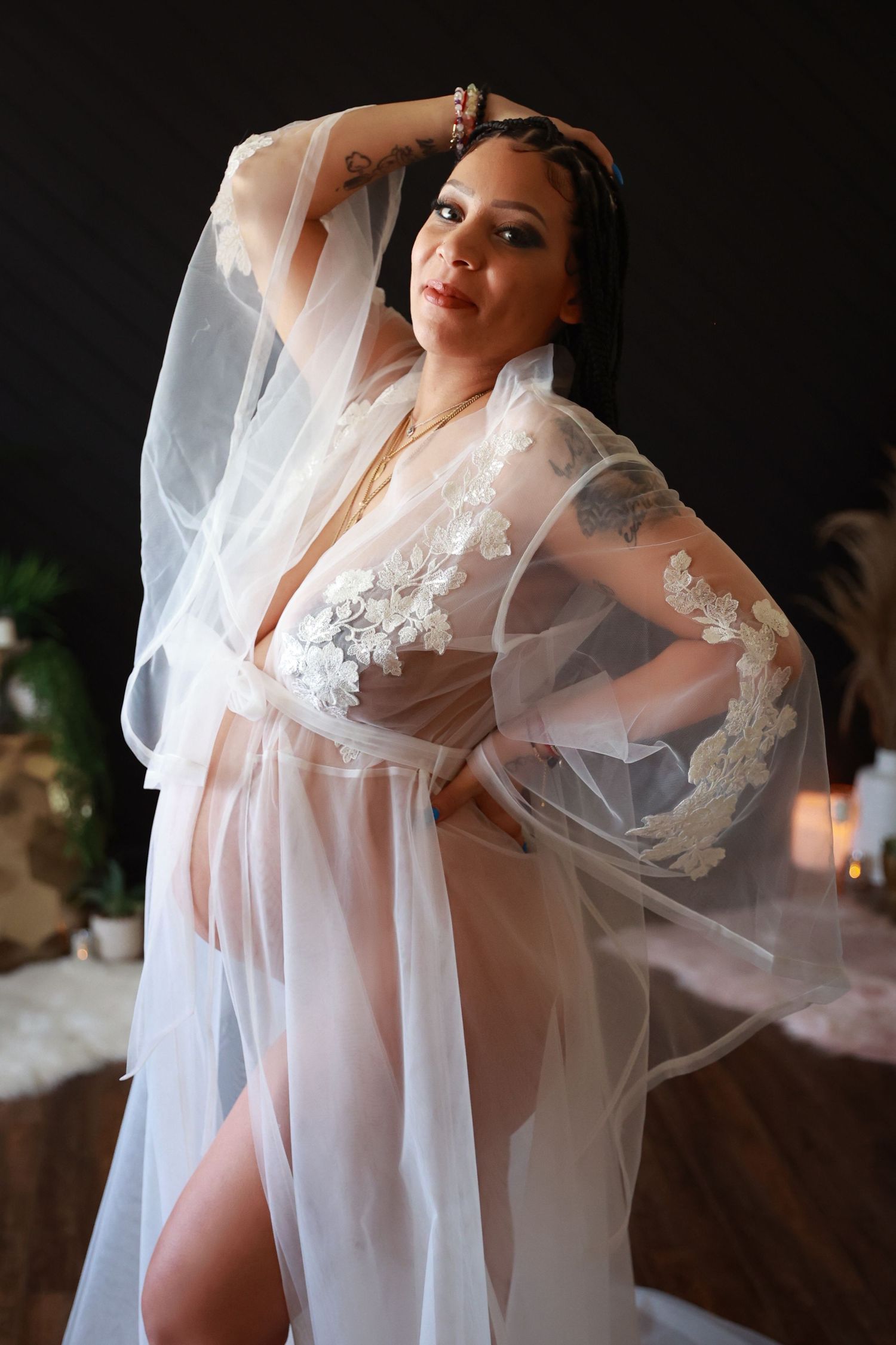 Ethereal bridal boudoir photo series showing flowing white sheer robe and veil against dark background.