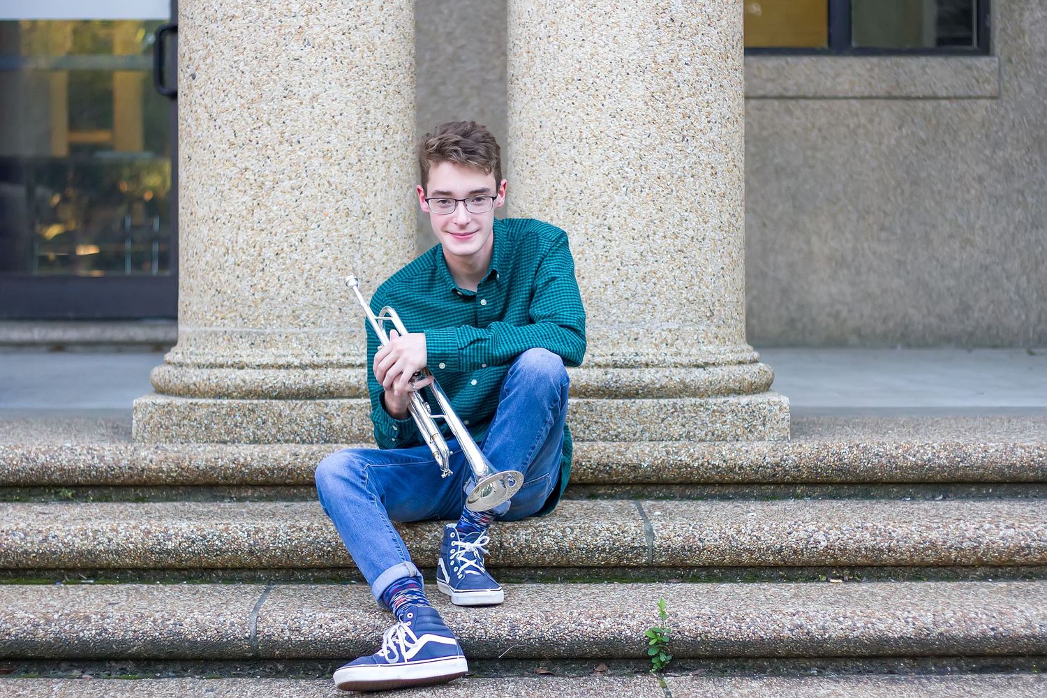 High School Senior with his trumpet on LSU campus for senior portraits.