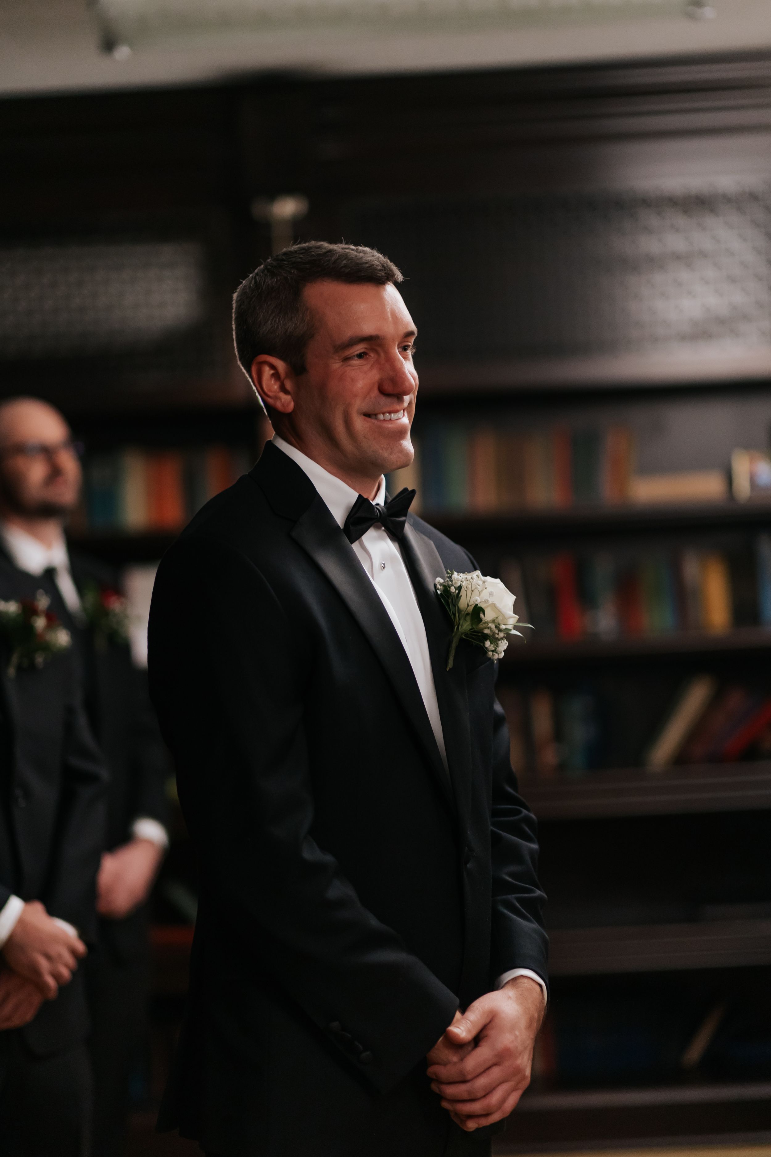 A series of black and white photos showing men in formal tuxedos and bow ties at an elegant indoor event.