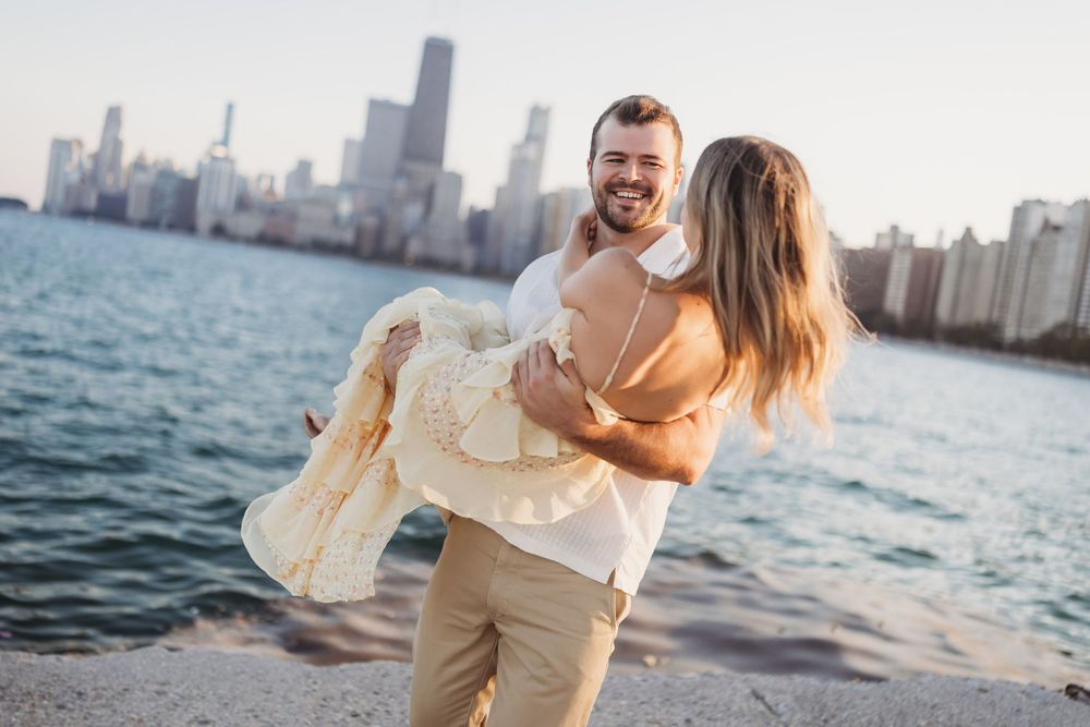 A romantic moment captured by the lake with downtown Chicago's skyline creating a stunning backdrop.