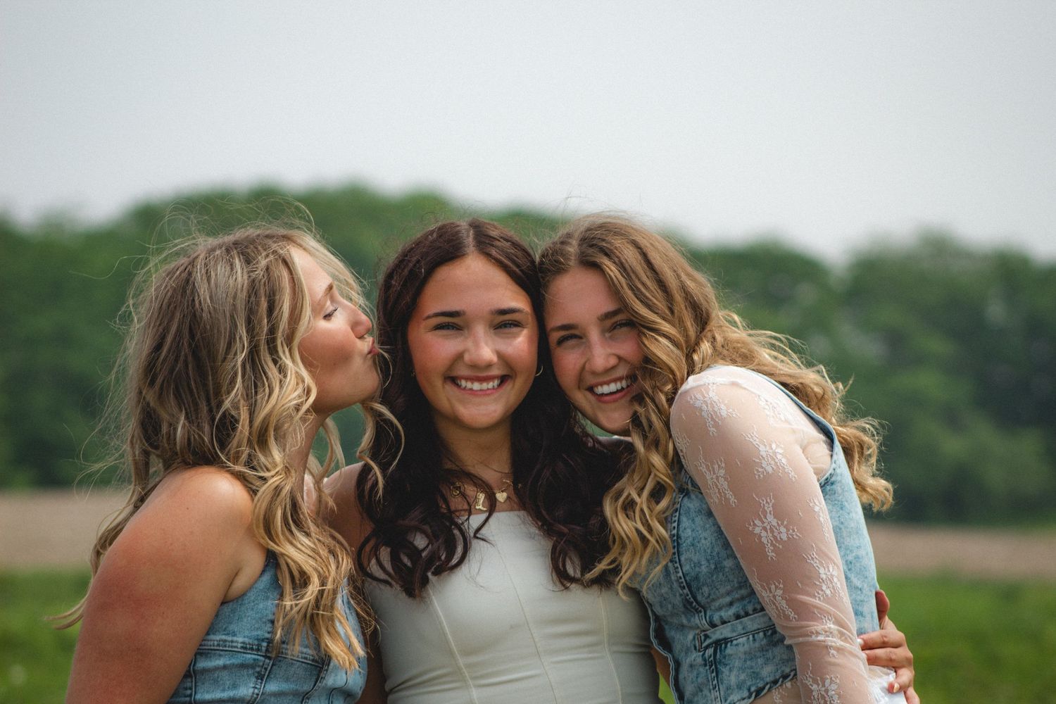 three sisters smiling for the photo