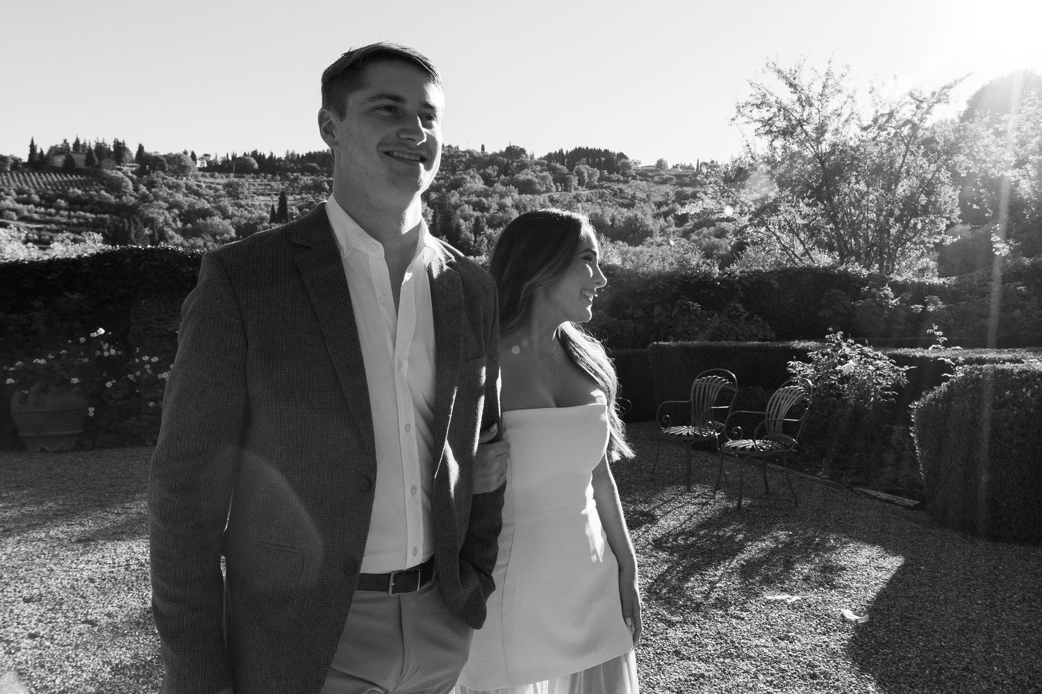 A romantic black and white sequence of a couple embracing under tree branches in an outdoor setting.