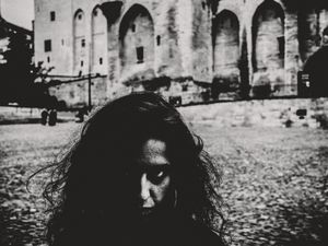 Model, 'Alix' hiding from her betrothed lover in front of Notre Dame des Doms, Avignon, France. October 2024