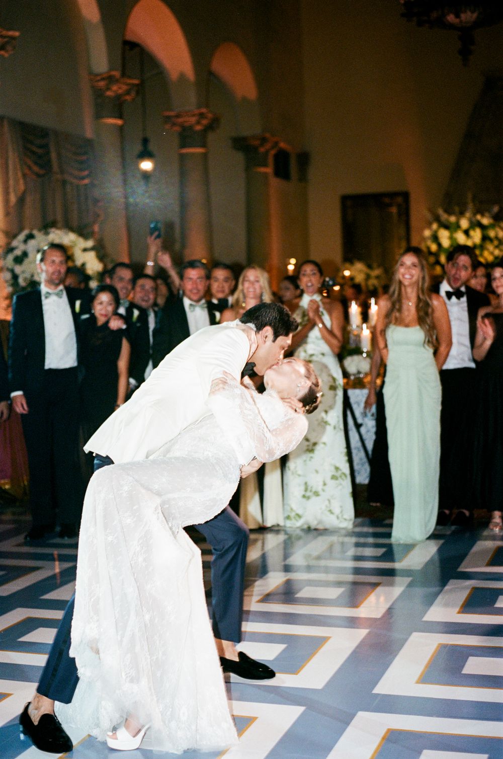 A sequence of wedding dance photos shows a couple performing a dramatic dip move on a geometric patterned dance floor.