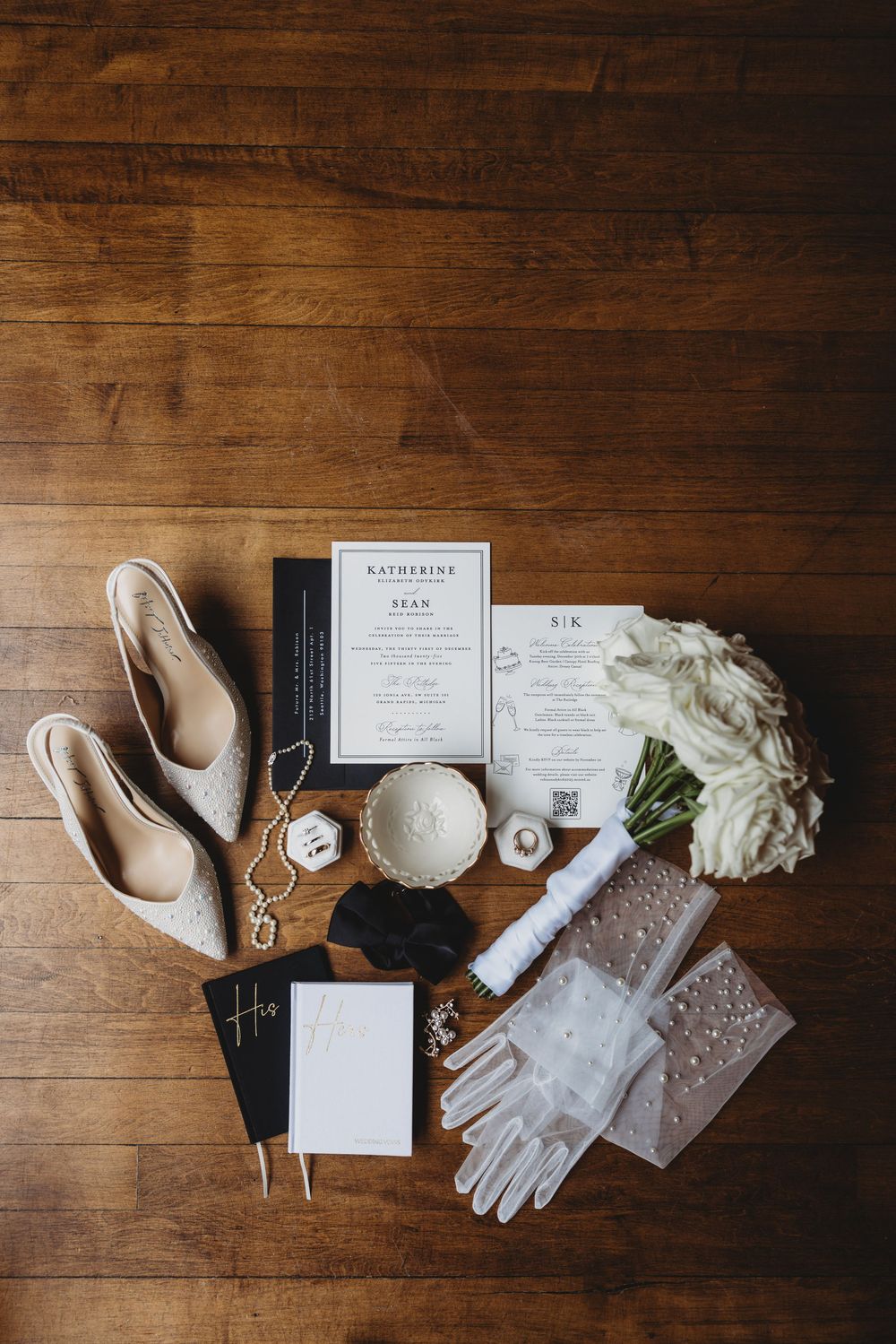 Wedding accessories and invitations artfully arranged on a rustic wooden surface.