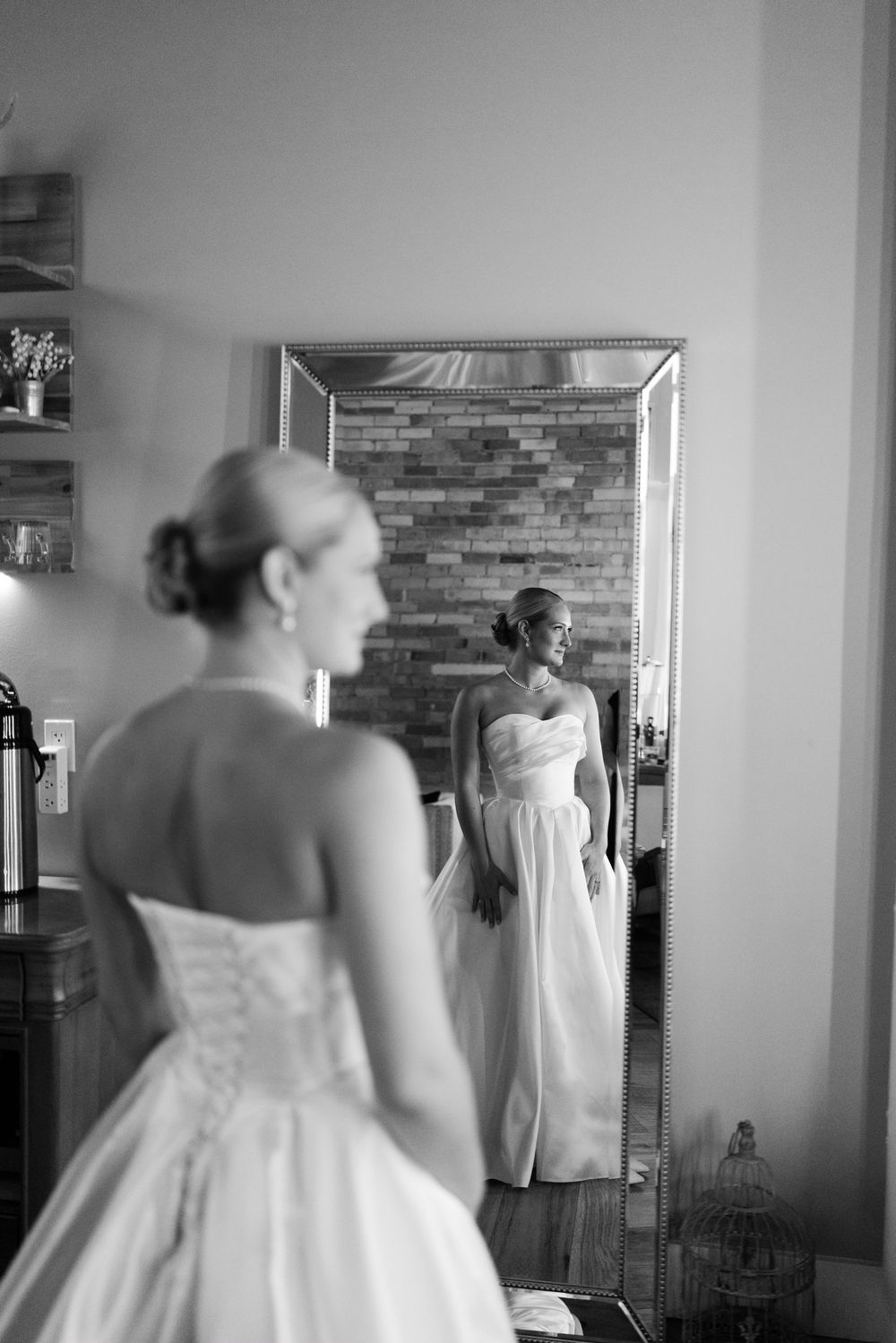 A sequence of black and white photos showing someone in a wedding dress preparing for their special day.