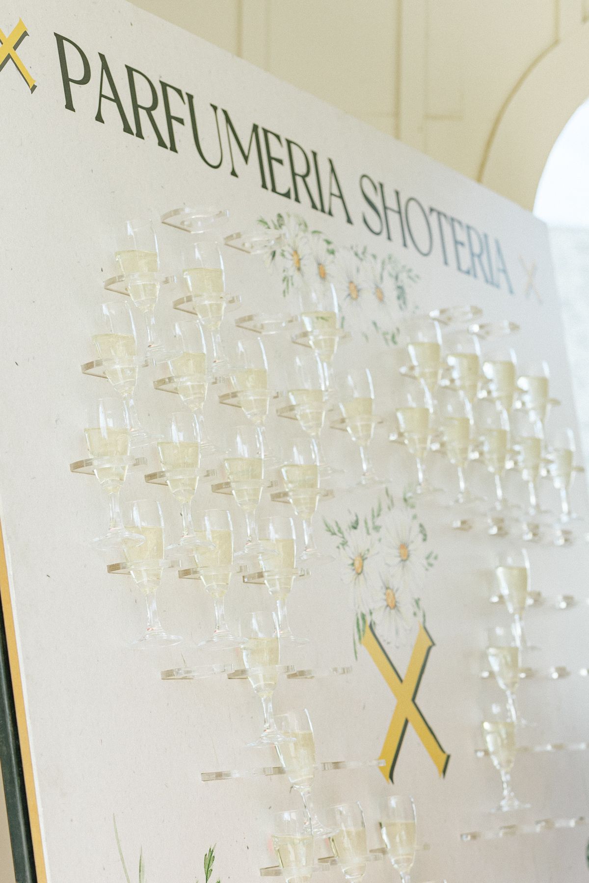 Decorative glass display with elegant text arrangement on a white wall.