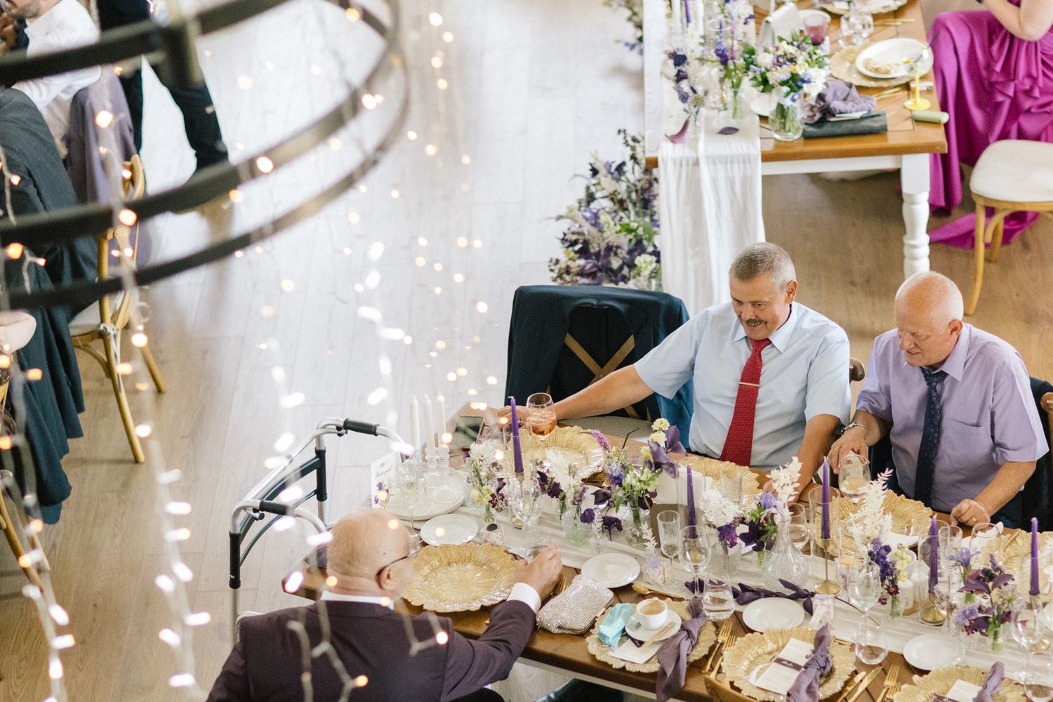 Elegant wedding reception table settings with crystal decorations and floral centerpieces.