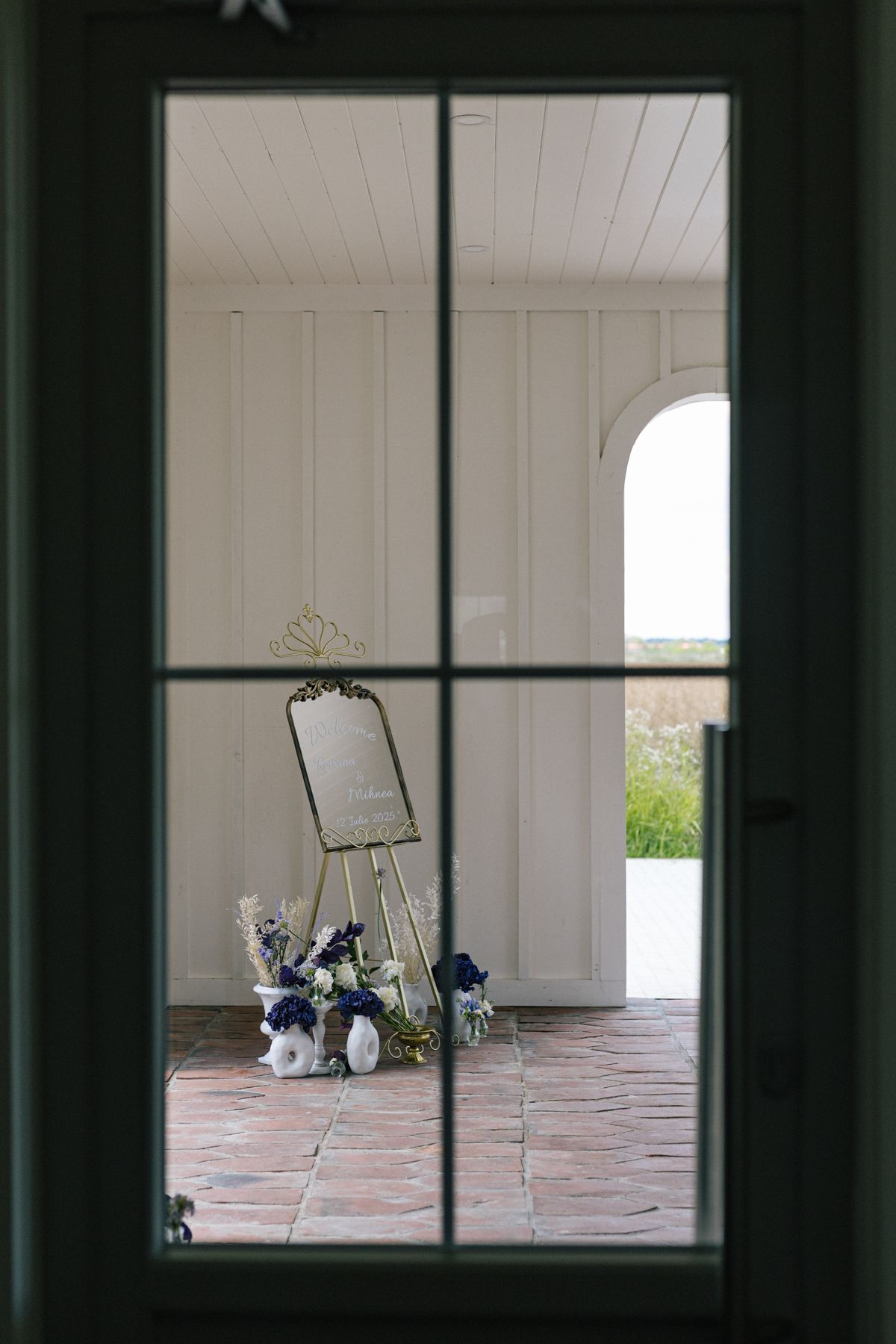 View through dark window panes into a bright white interior space.