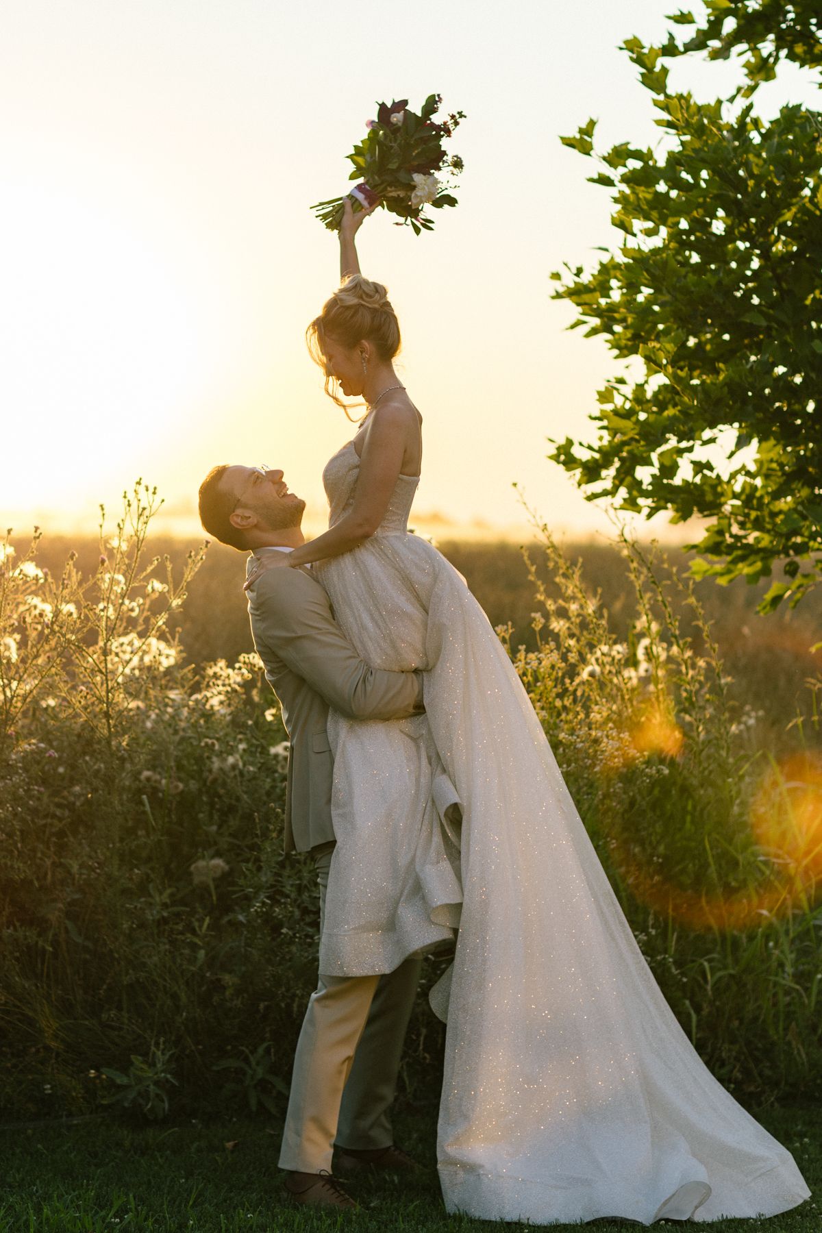 Sunset wedding photoshoot features romantic lifts and poses in a garden setting.