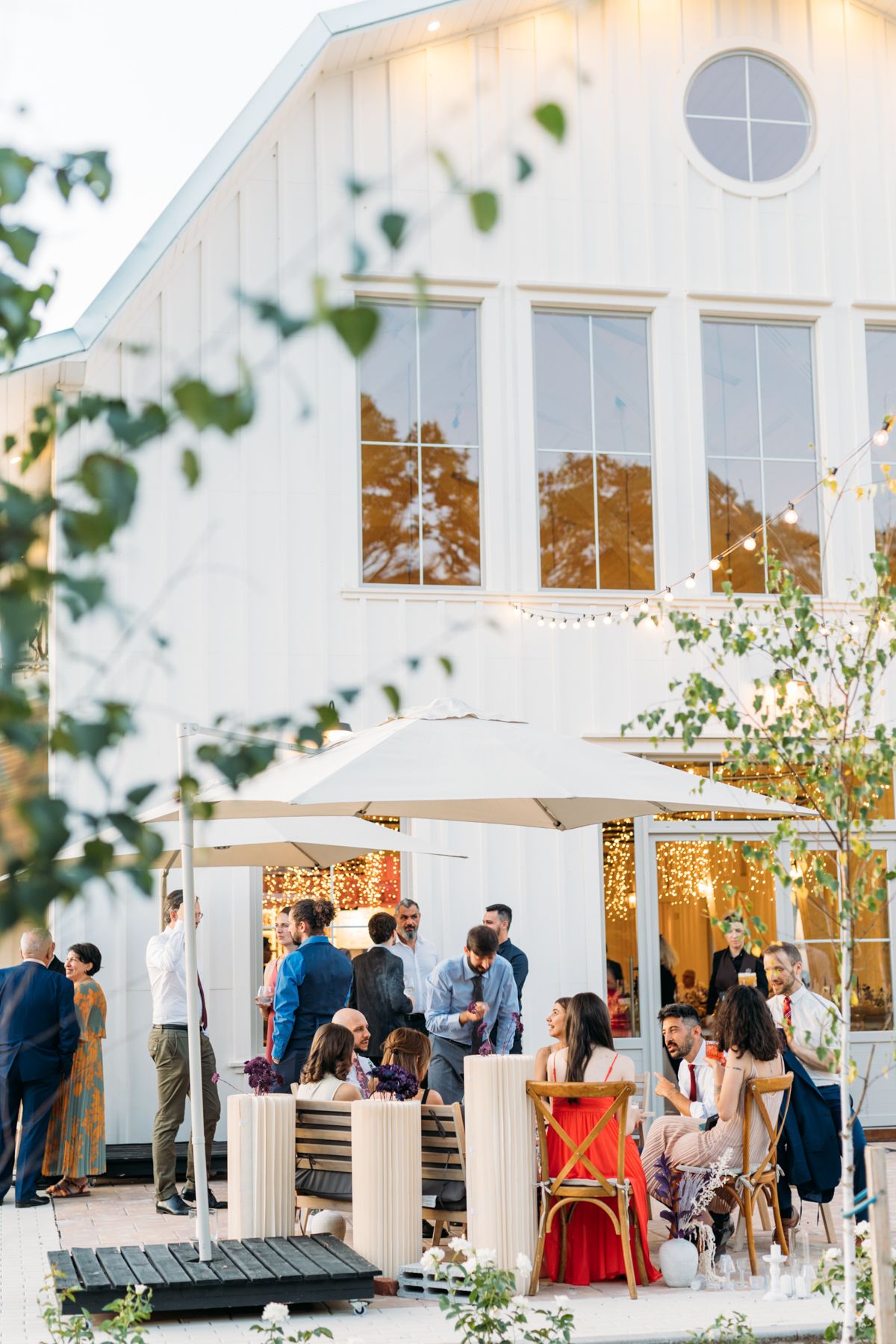 Wedding reception setup with string lights and white tent at The White Manor.
