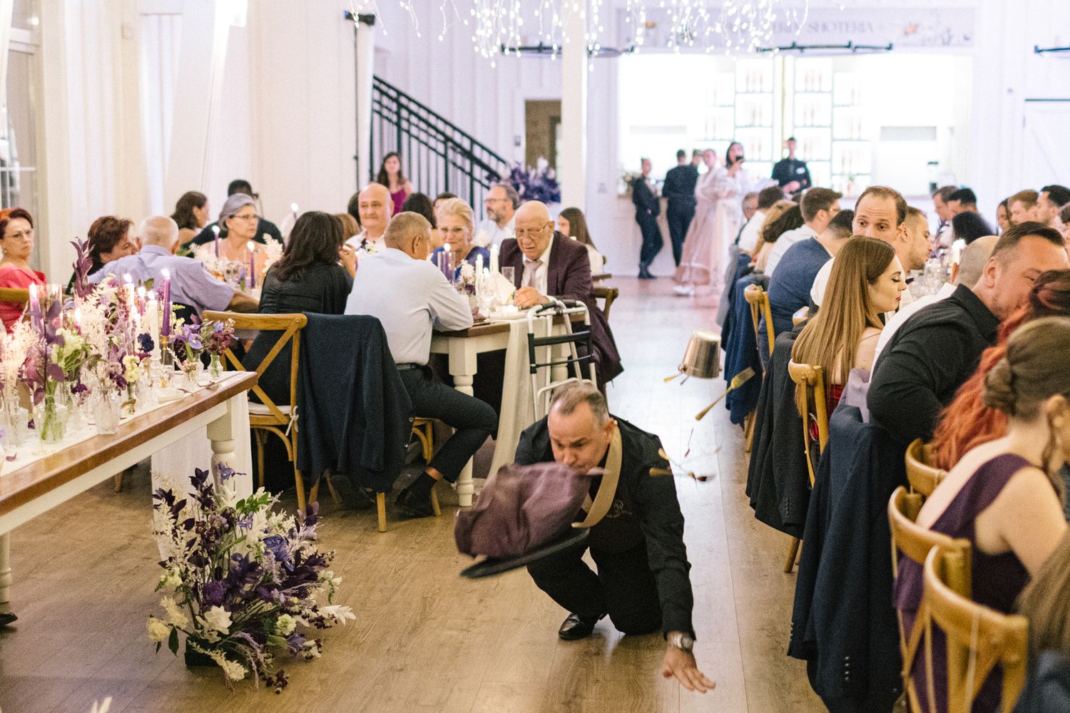 Large reception hall with guests gathered for a formal celebration.