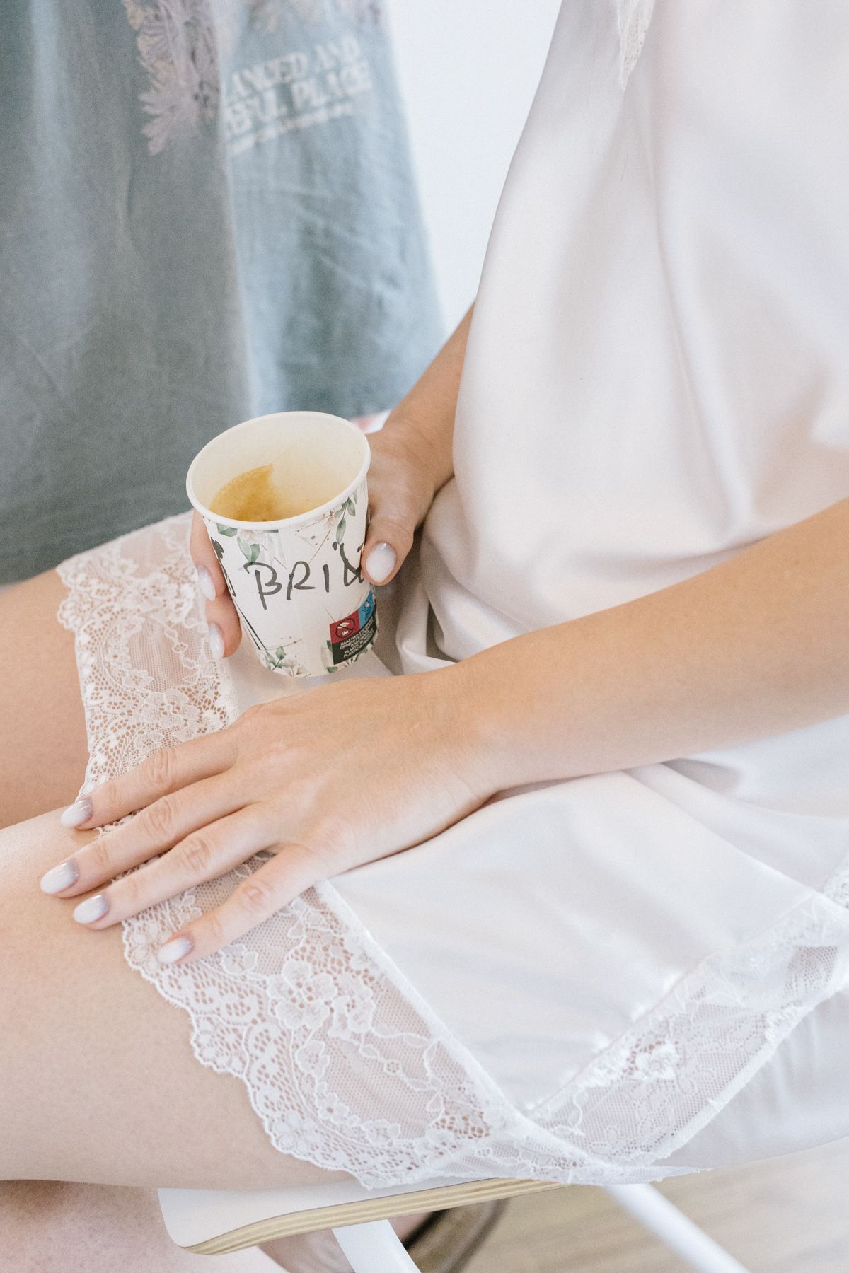 Hands arranging white lace fabric with delicate details.