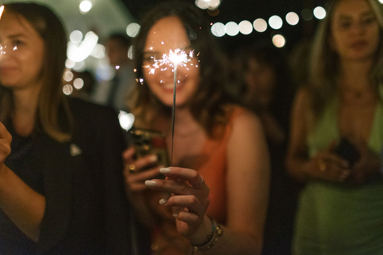 Evening celebration with string lights creating a magical bokeh effect in the background.