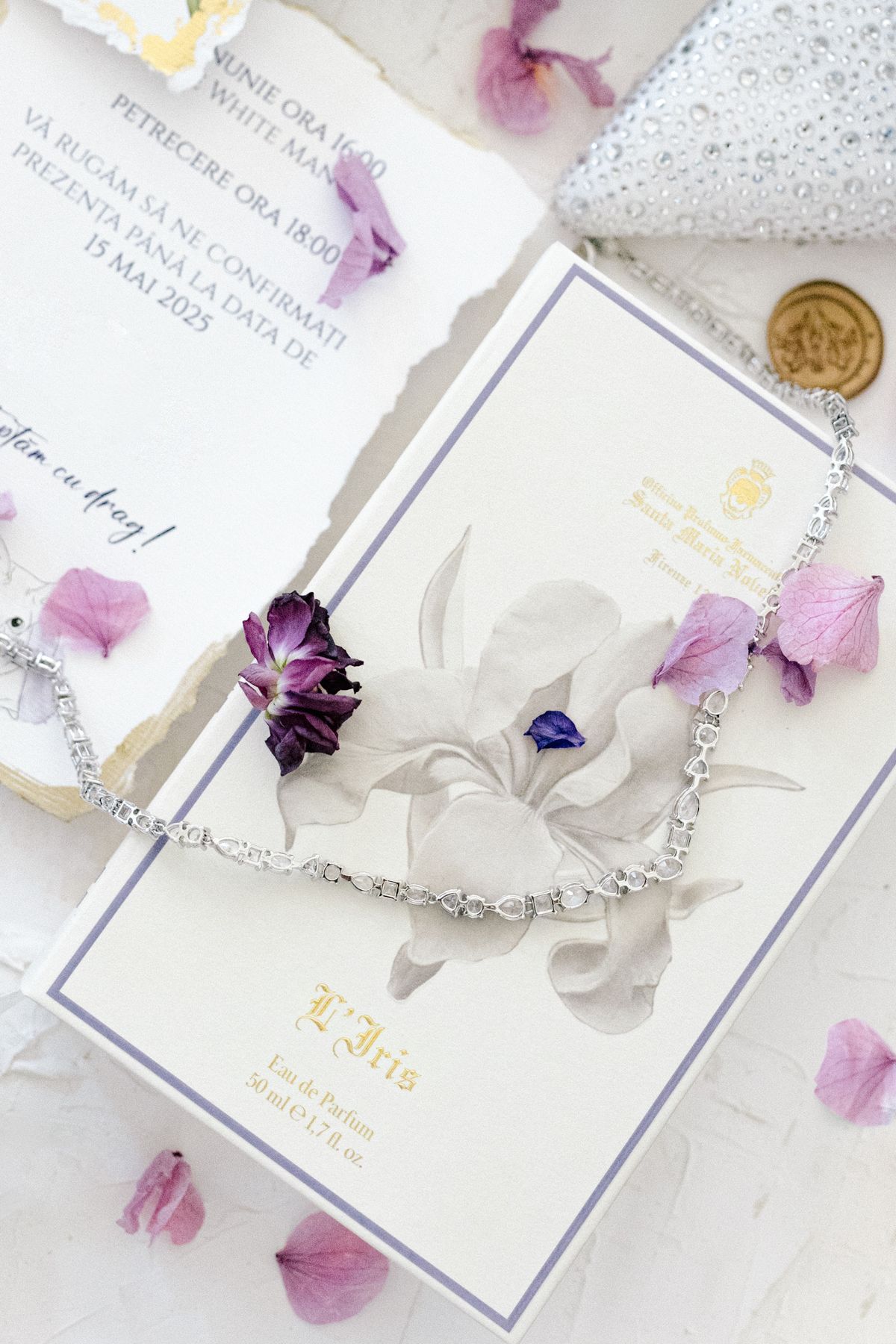 Wedding stationery suite with purple watercolor details and delicate floral petals.