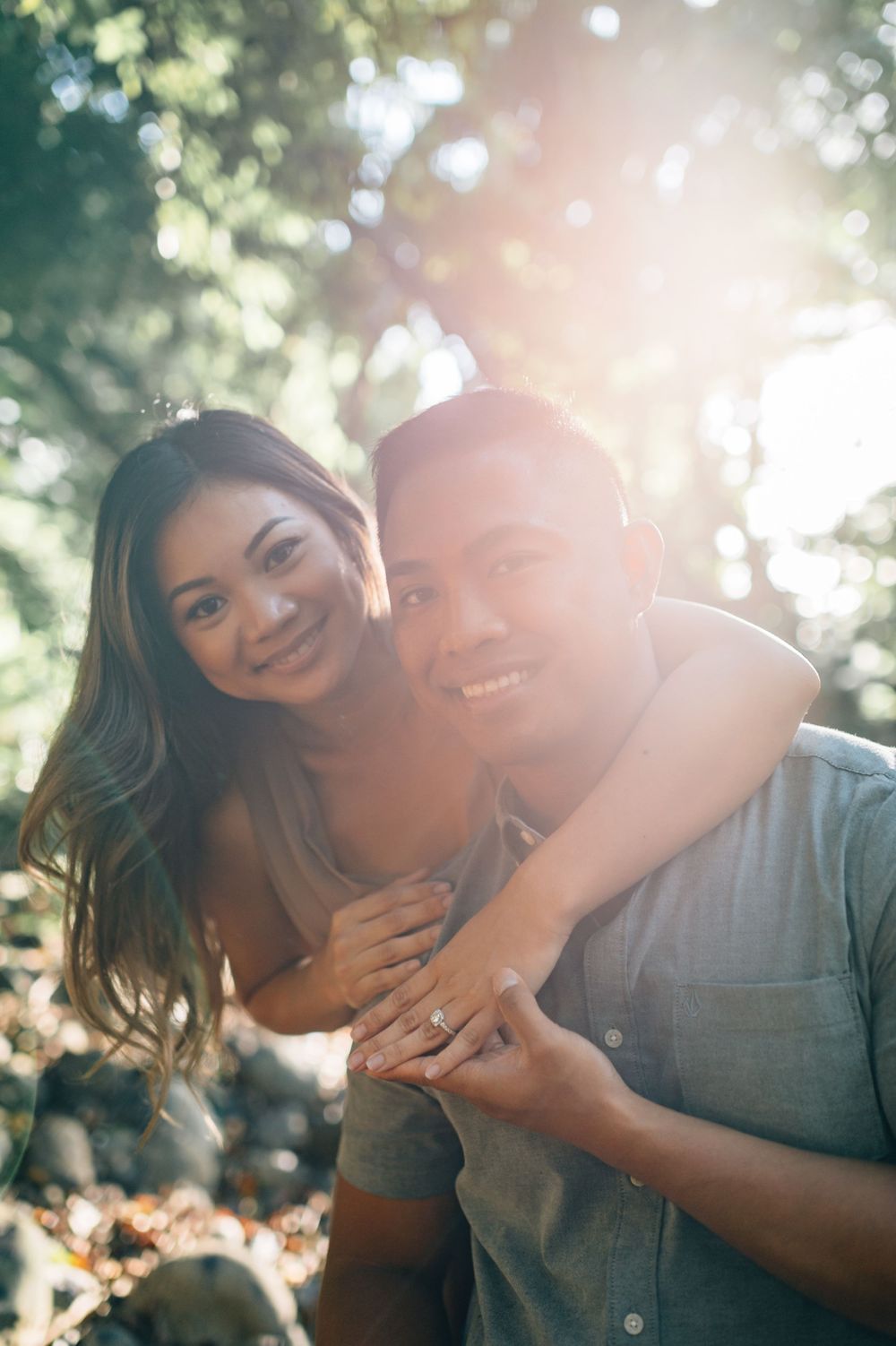 A romantic couple shares intimate close-up moments in a sunlit outdoor setting.