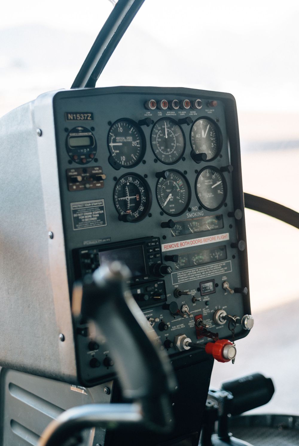 Vintage aircraft instrument panel showing analog gauges and controls in black and white.