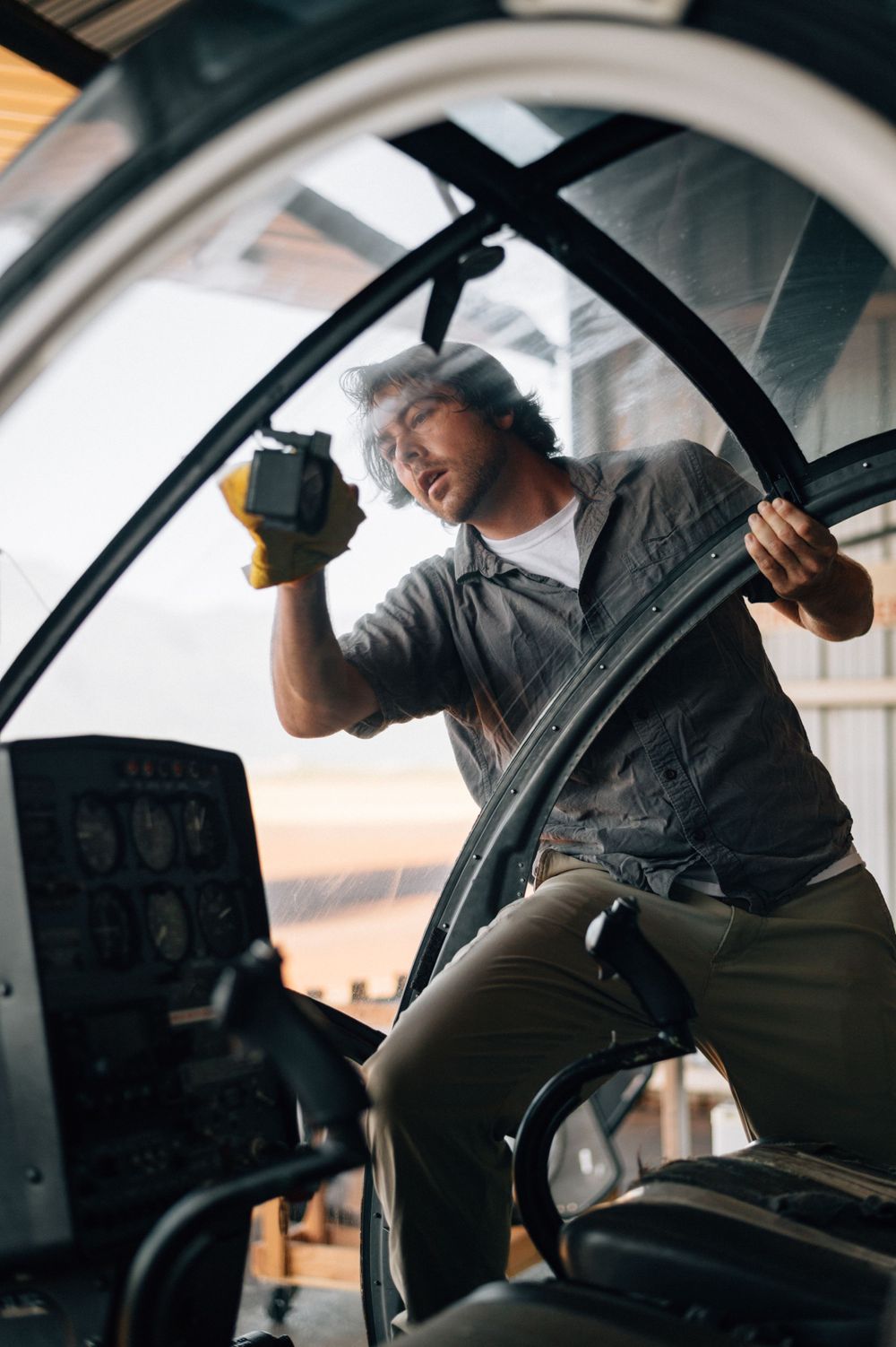 Interior view of helicopter cockpit controls during flight operations.