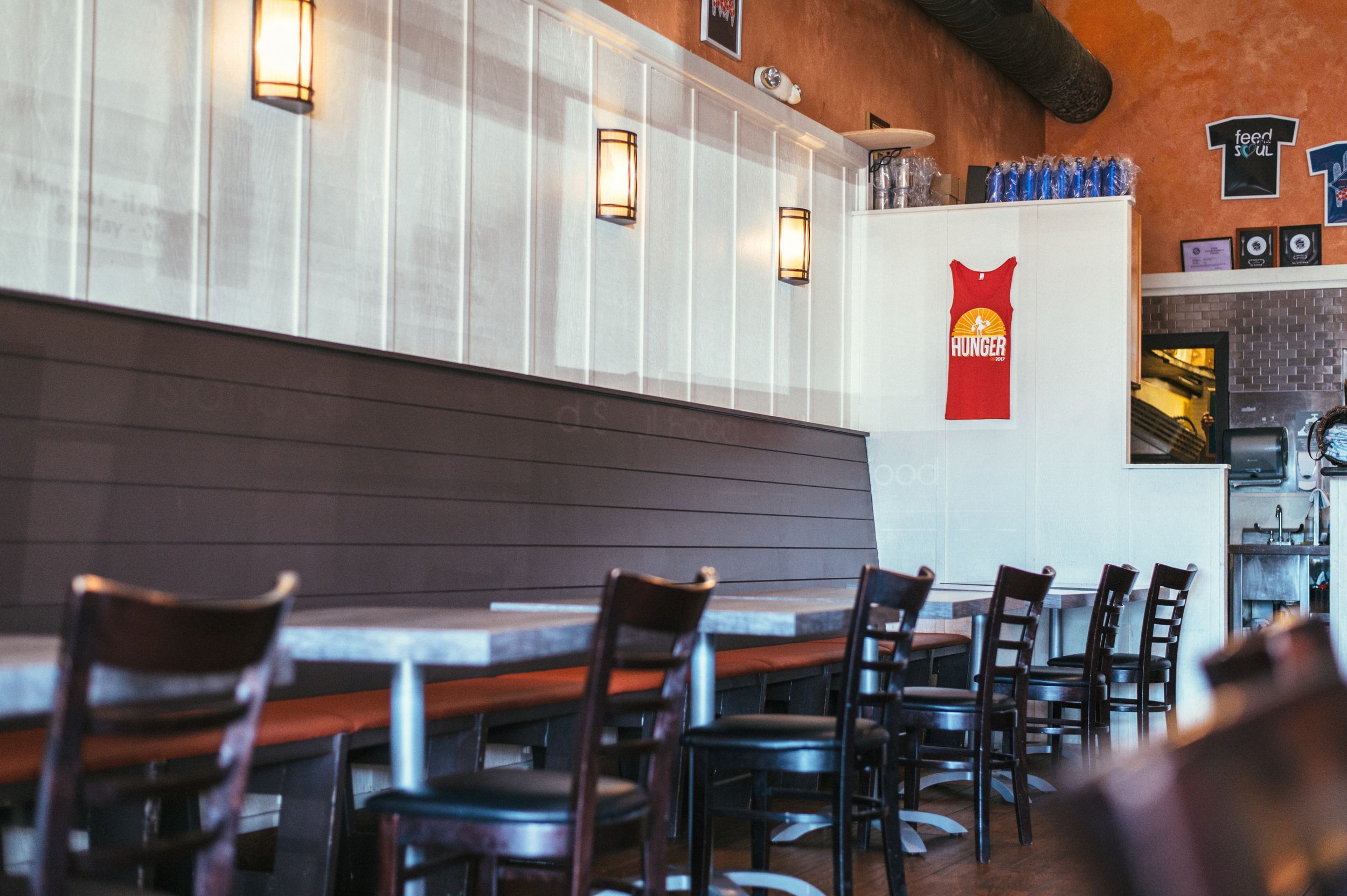 Interior of casual dining restaurant with wall sconces and booth seating.