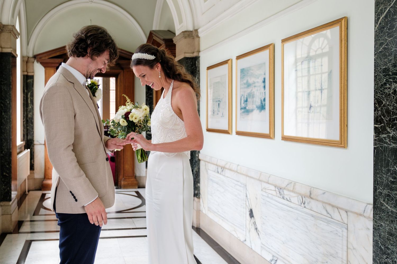 Newlyweds looking at wedding ring at Islington Town Hall