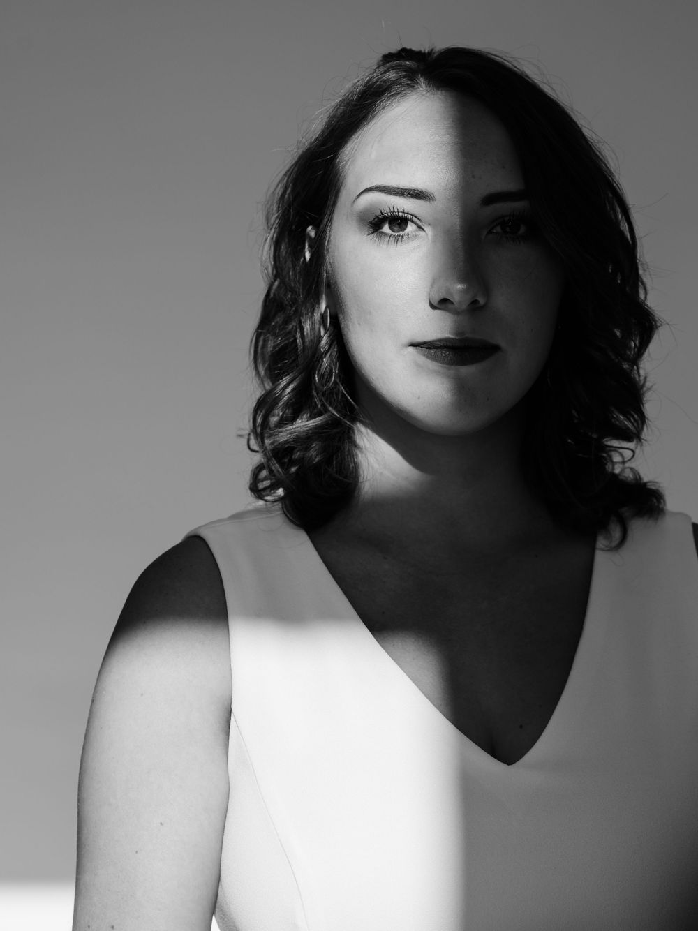 Black and white artistic portraits with dramatic shadows and contrast.