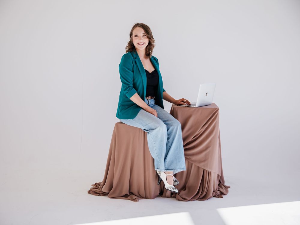 Professional photography session setup with brown fabric backdrop in white studio space.
