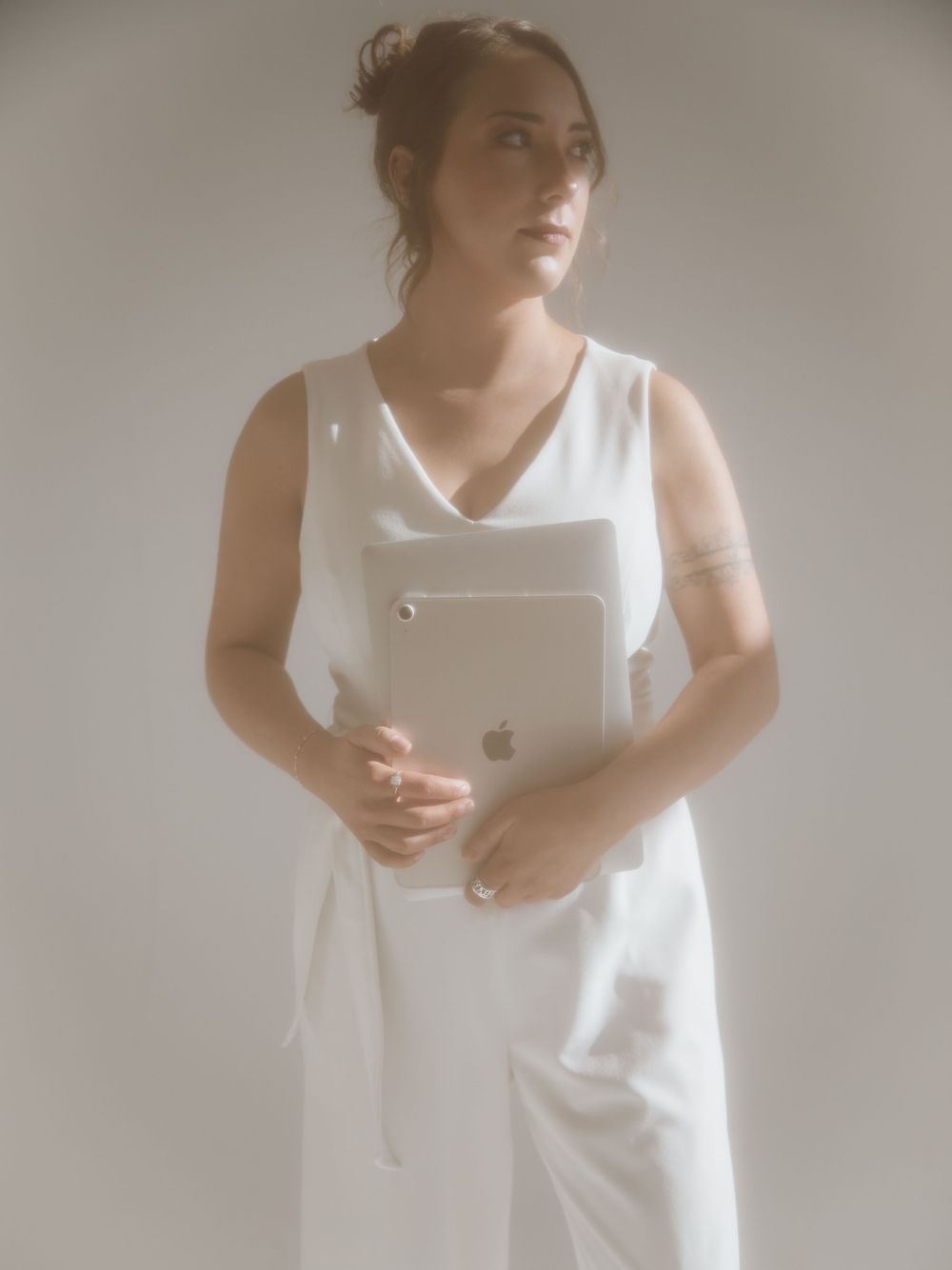 A series of minimalist fashion portraits in white showing elegant poses against a light background.