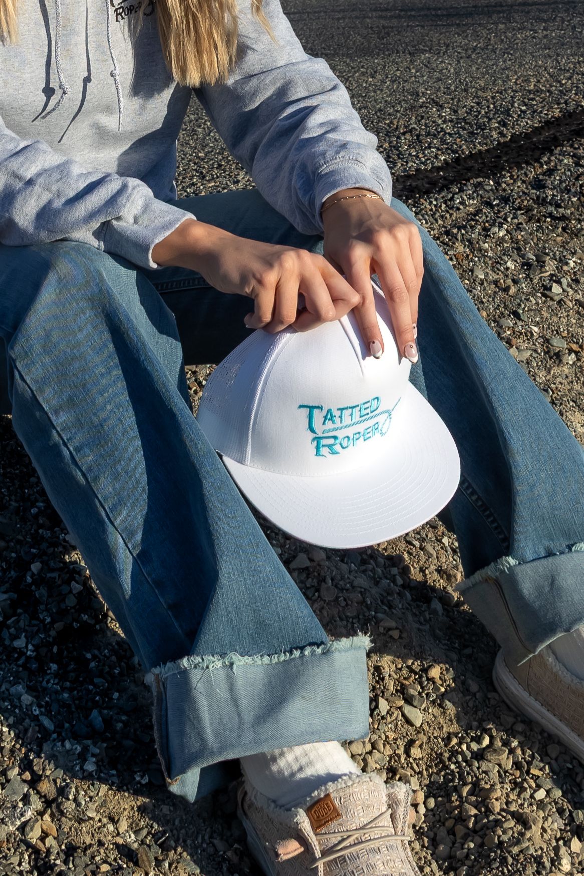 A sequence of photos showing someone holding and examining a white frisbee disc on gravel ground.