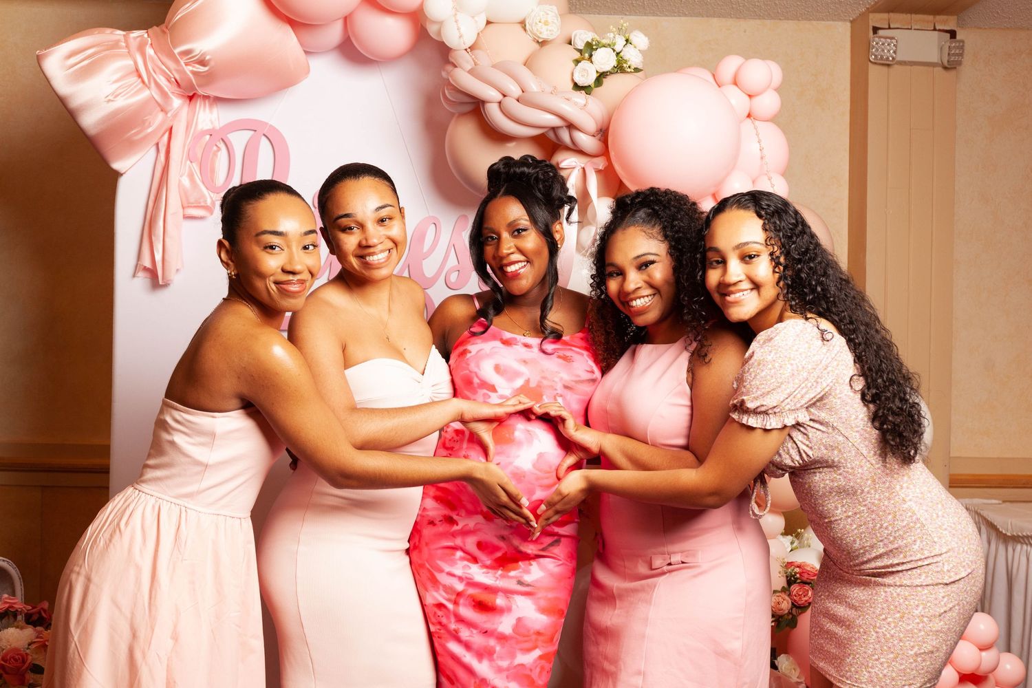 Wedding party wearing pink and white dresses pose together in a series of joyful celebration photos.