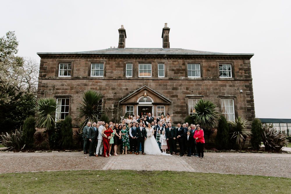 A series of panoramic shots showing a historic stone manor house with wedding guests gathered outside on a cloudy day.